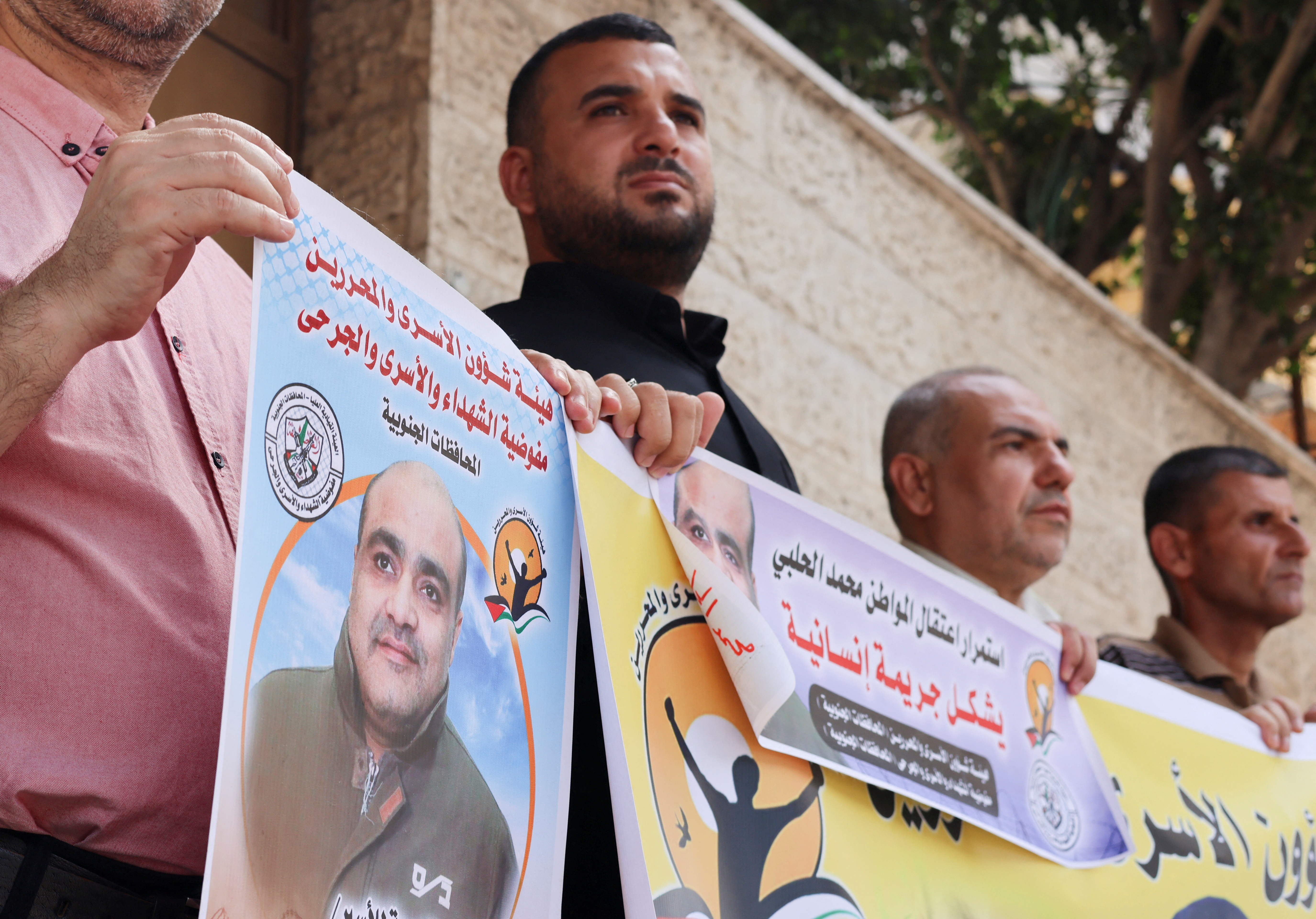 People hold pictures of Mohammad al-Halabi