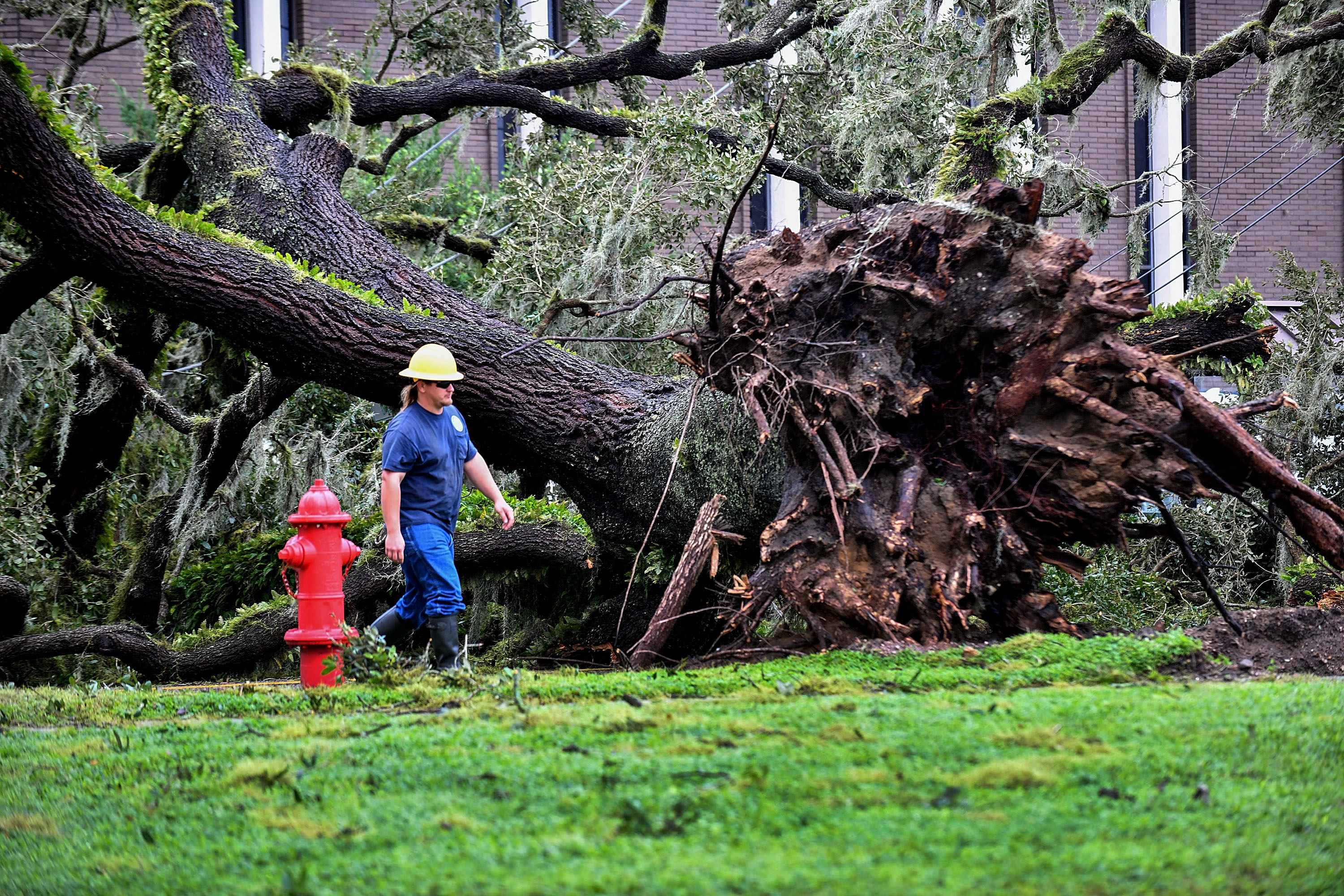 A worker repairs energy lines during a power outage after Hurricane Ian passed through the area