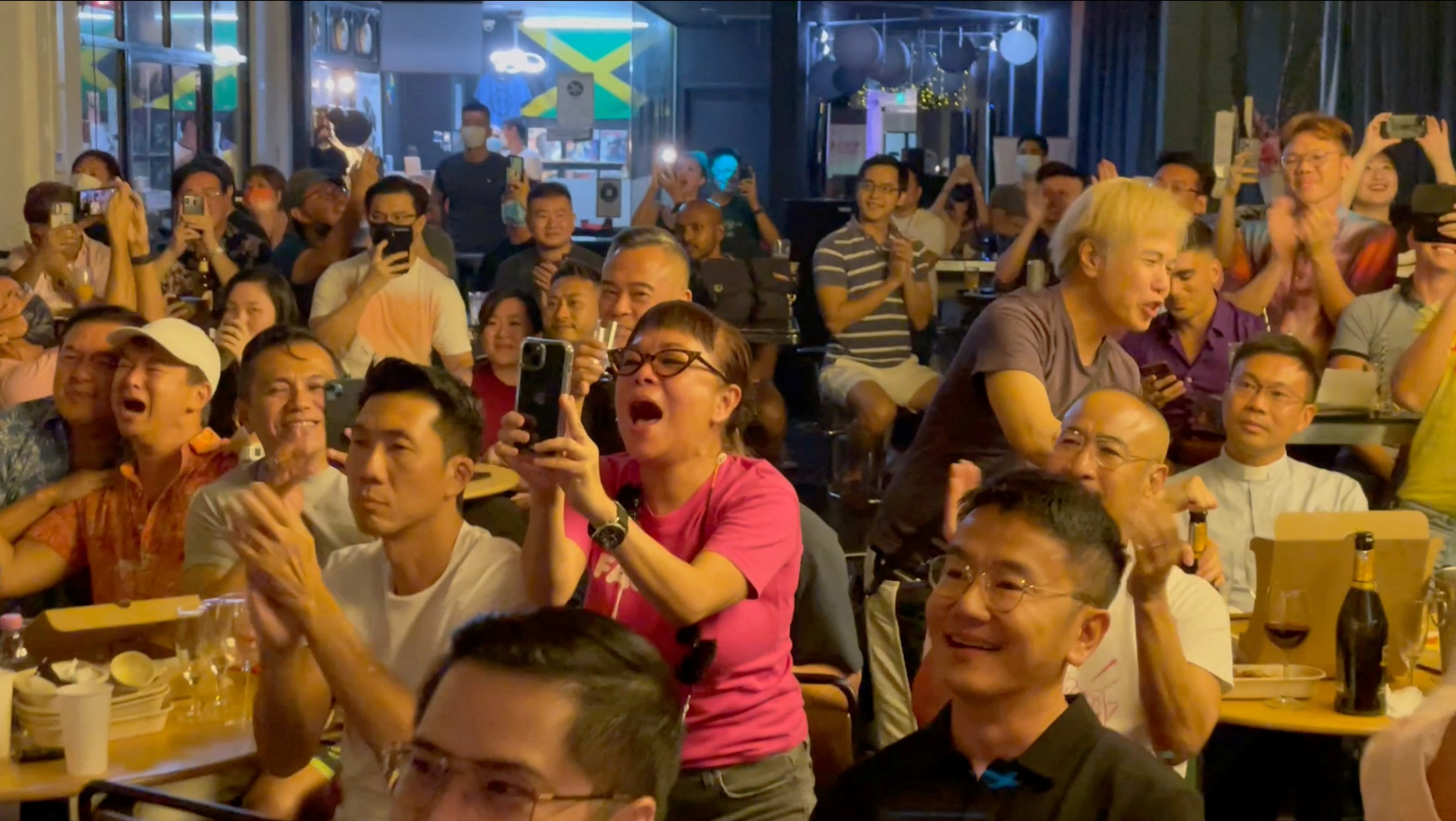 People cheer as Singapore’s Prime Minister Lee Hsien Loong announces that Singapore will decriminalise sex between men in a step forward for gay rights in the city-state