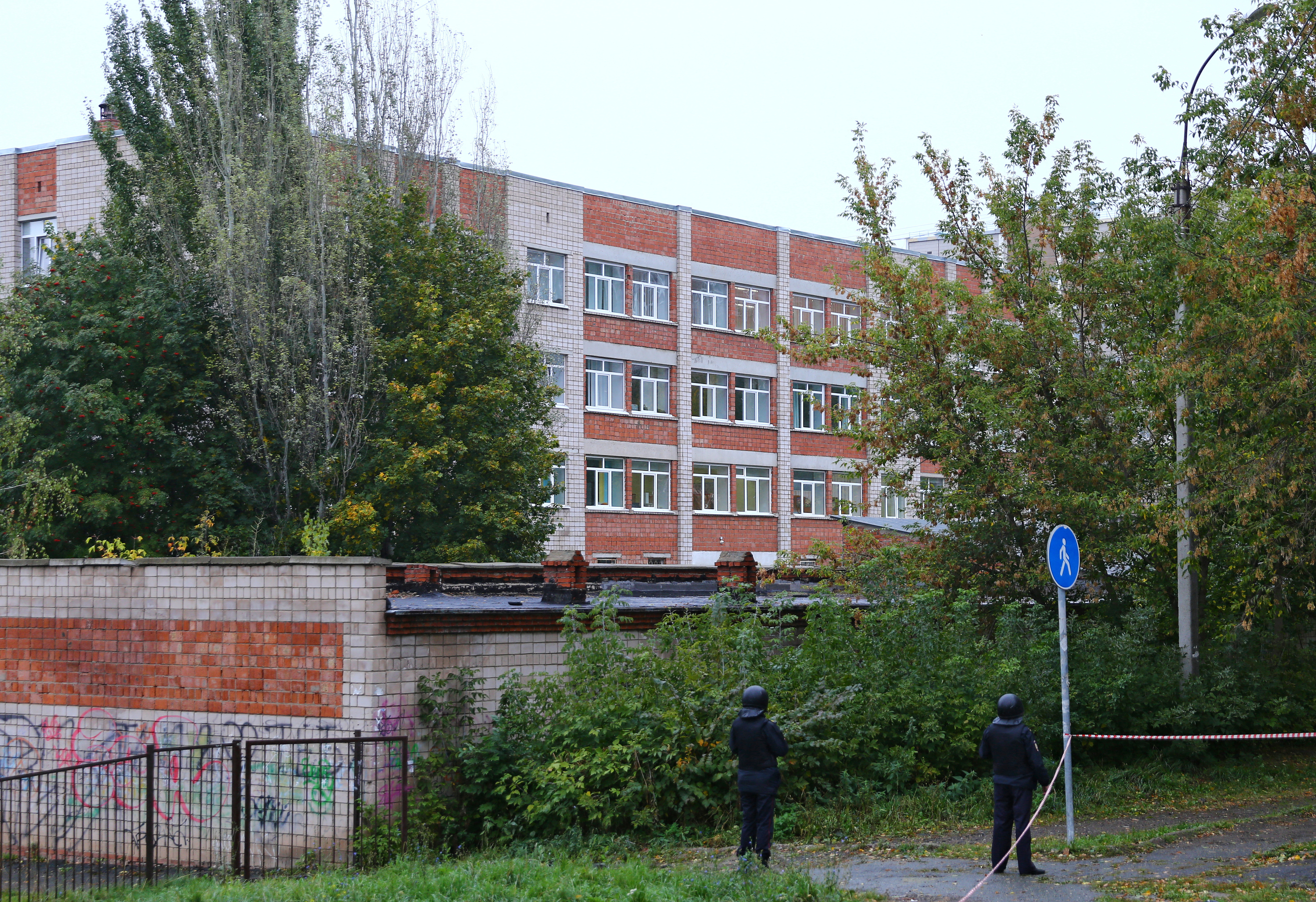 Police officers secure the area near the school.