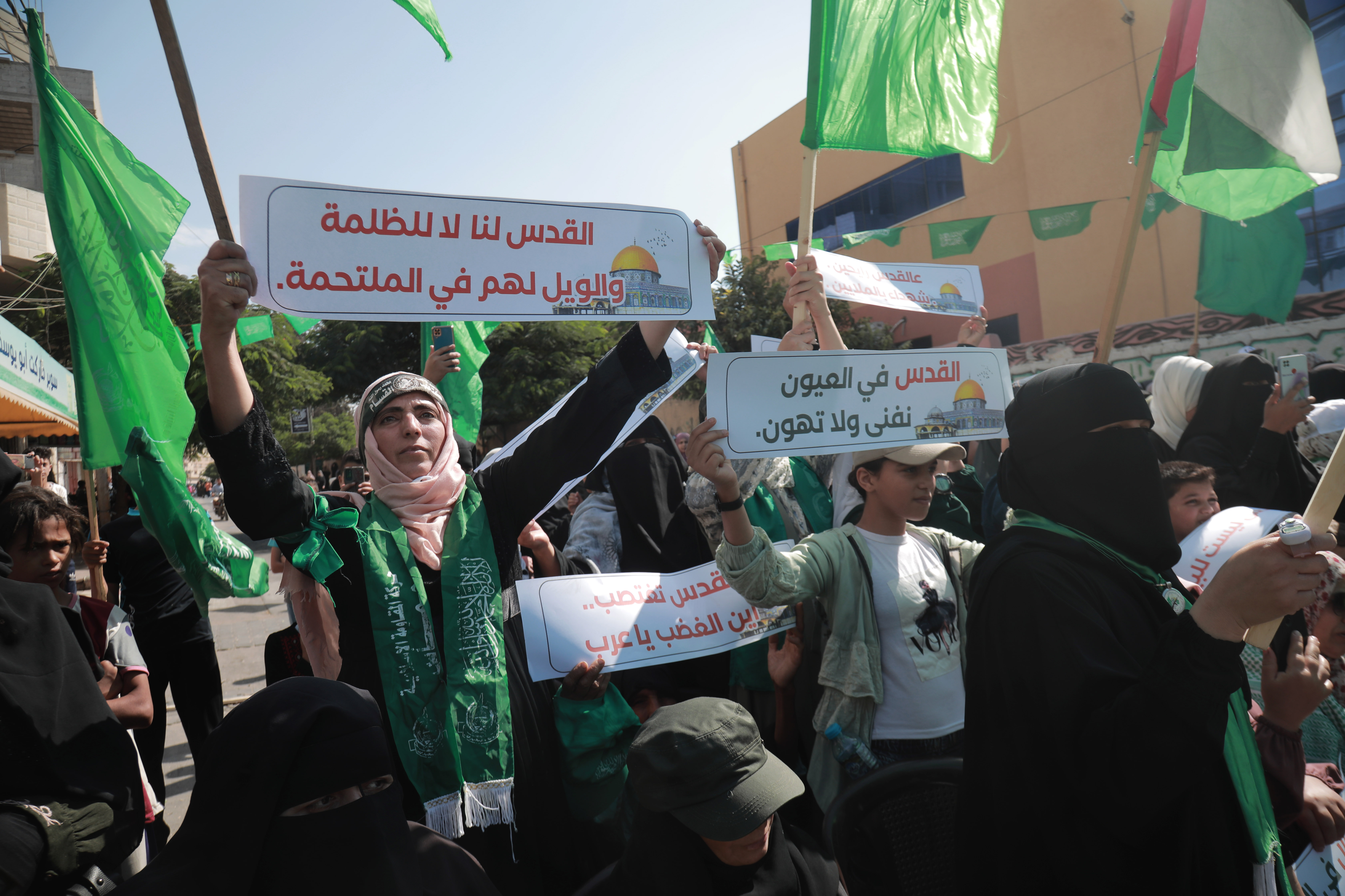A woman holds a banner