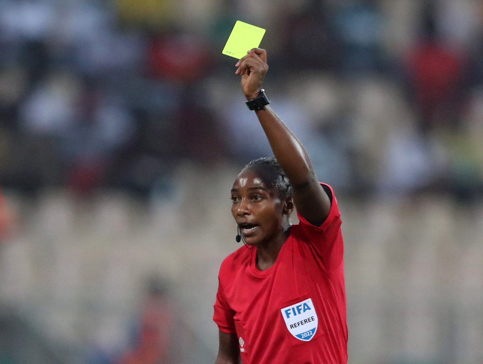 Referee Salima Mukansanga shows a yellow card to Zimbabwe's Talbert Shumba REUTERS/Mohamed Abd El Ghany