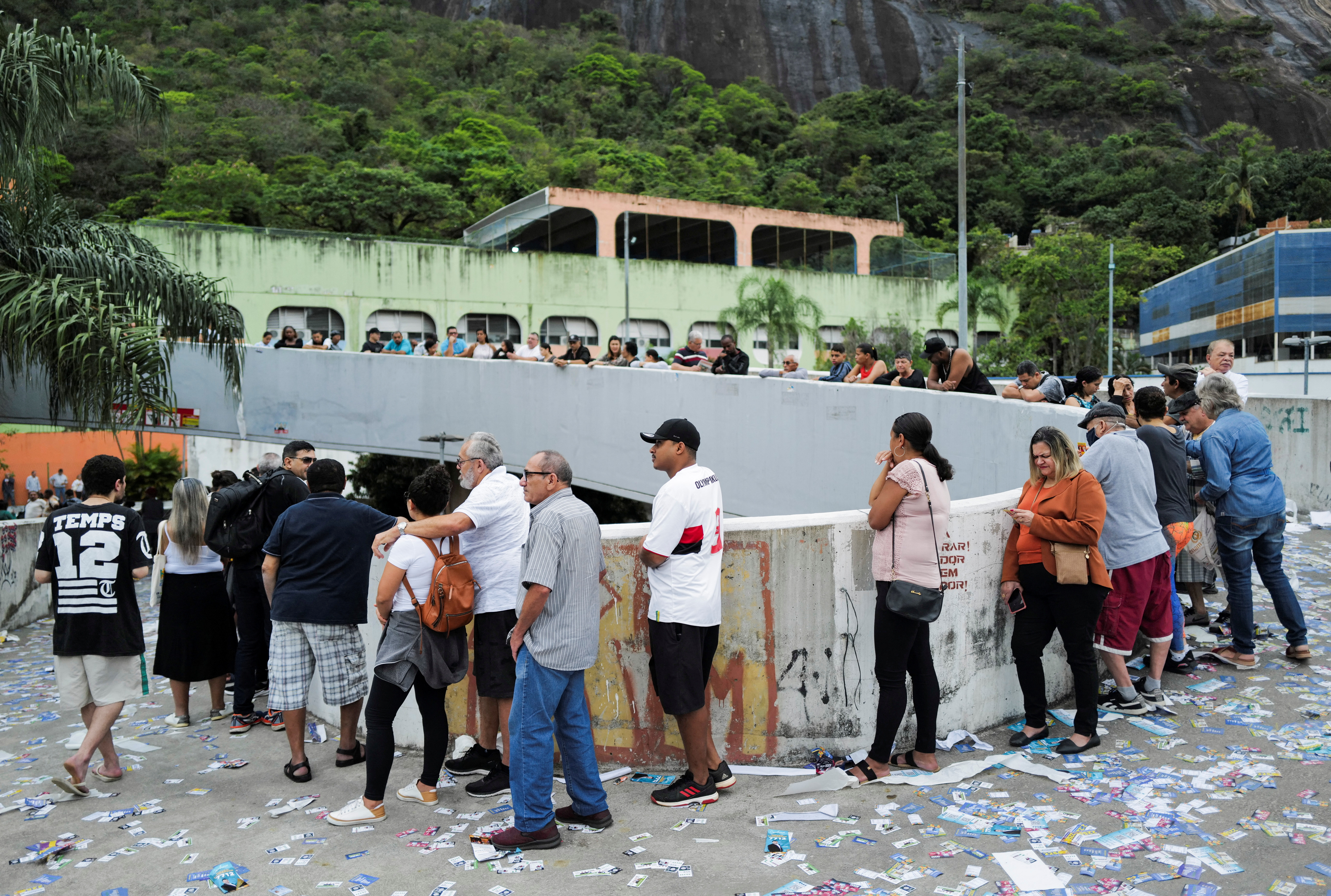 People stand in line to cast their votes outside a polling station, in Rio de Janeiro, Brazil.