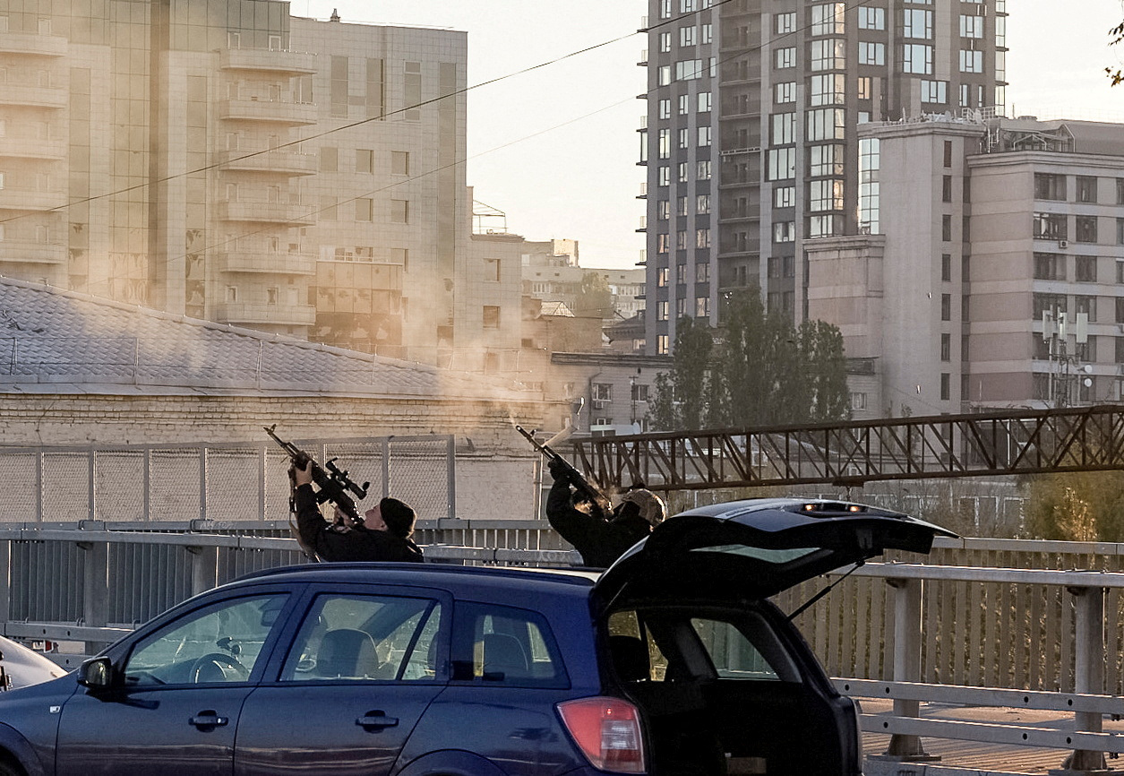 Police officers shoot at a drone in Kyiv, Ukraine.