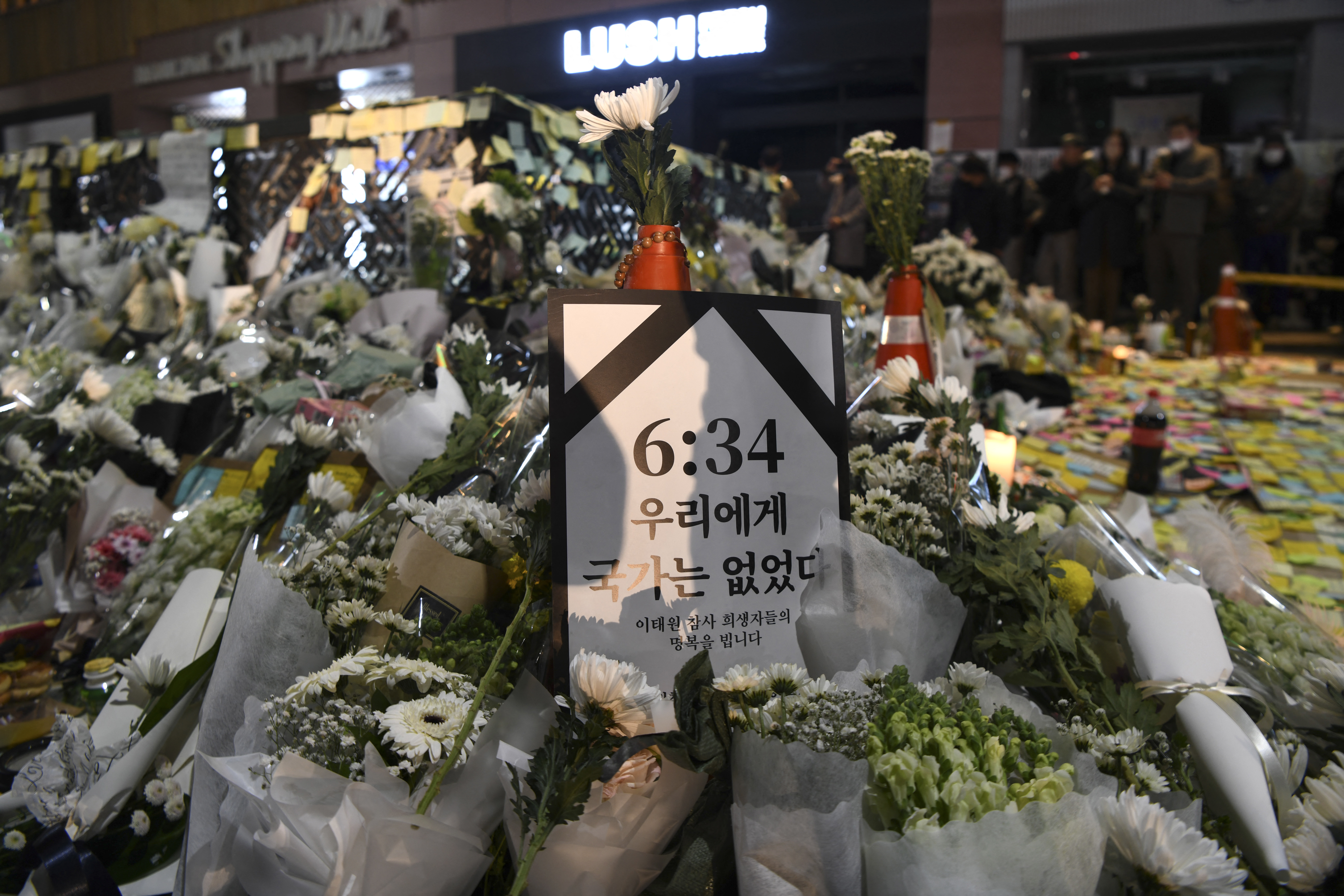 A poster with the time 6:34 (PM) which refers to the first call made to police on the night of a deadly Halloween crowd crush.