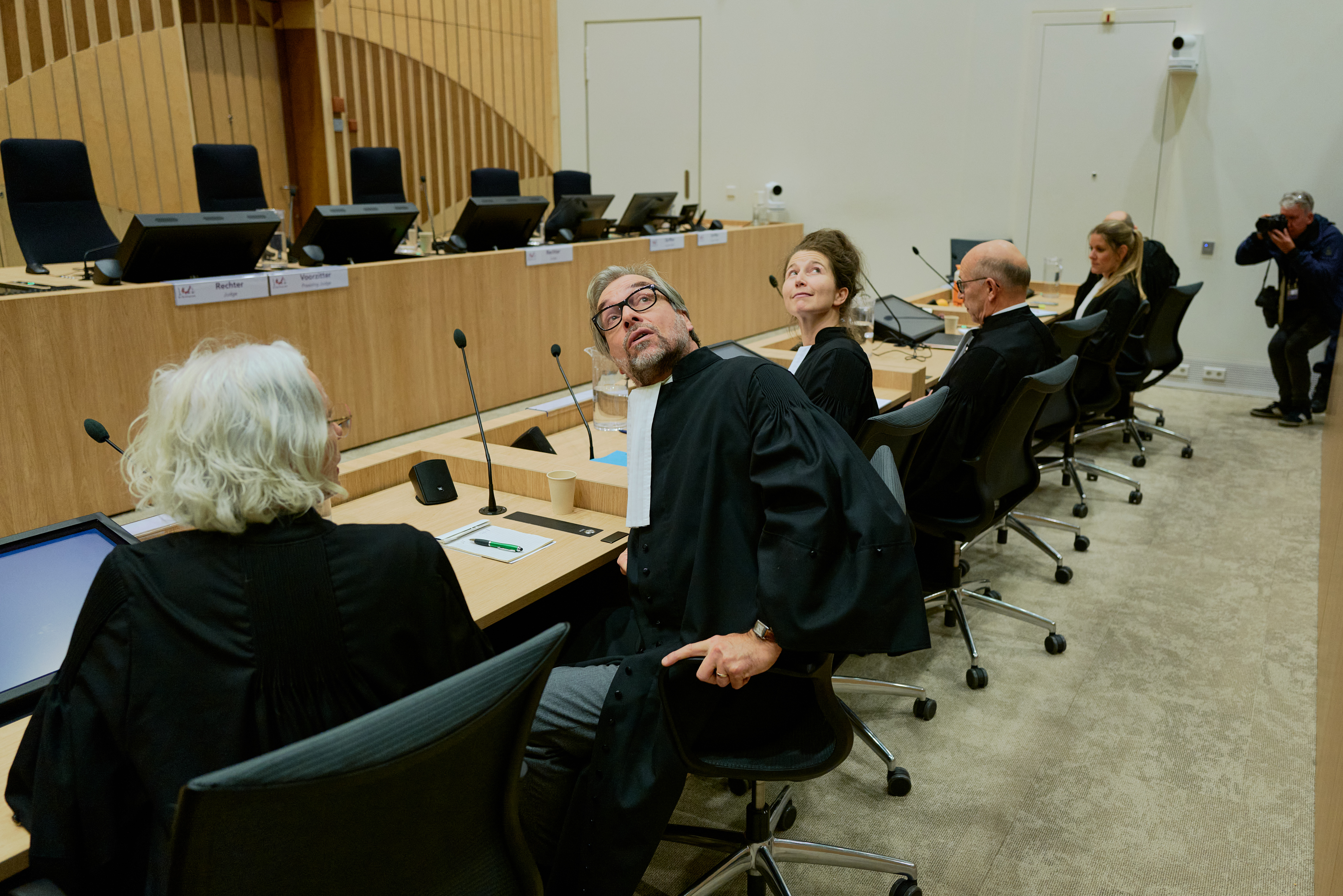Lawyers defending the relatives of the victims look at relatives of victims.