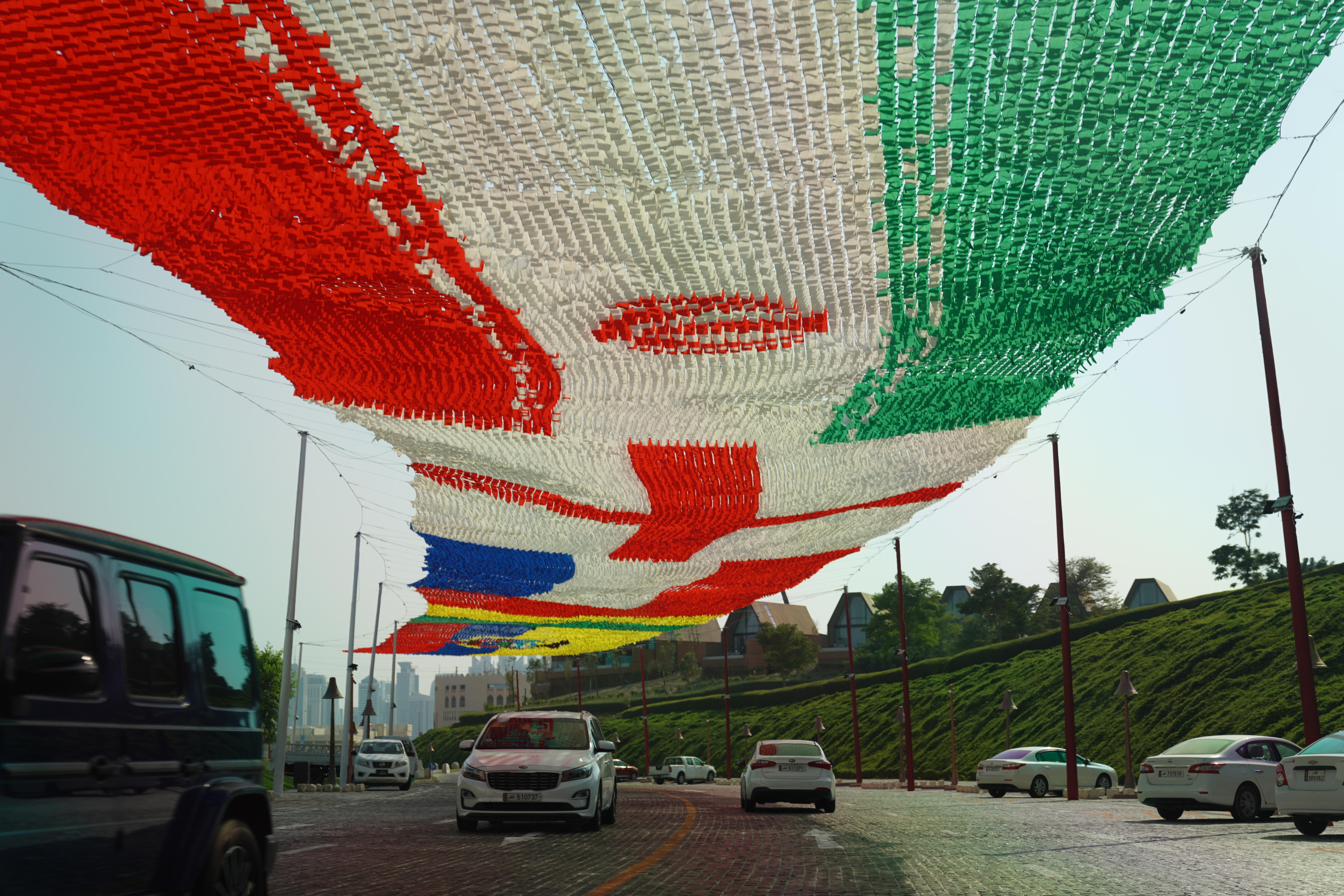 Flags of participating teams are shown at Katara in Doha, Qatar.