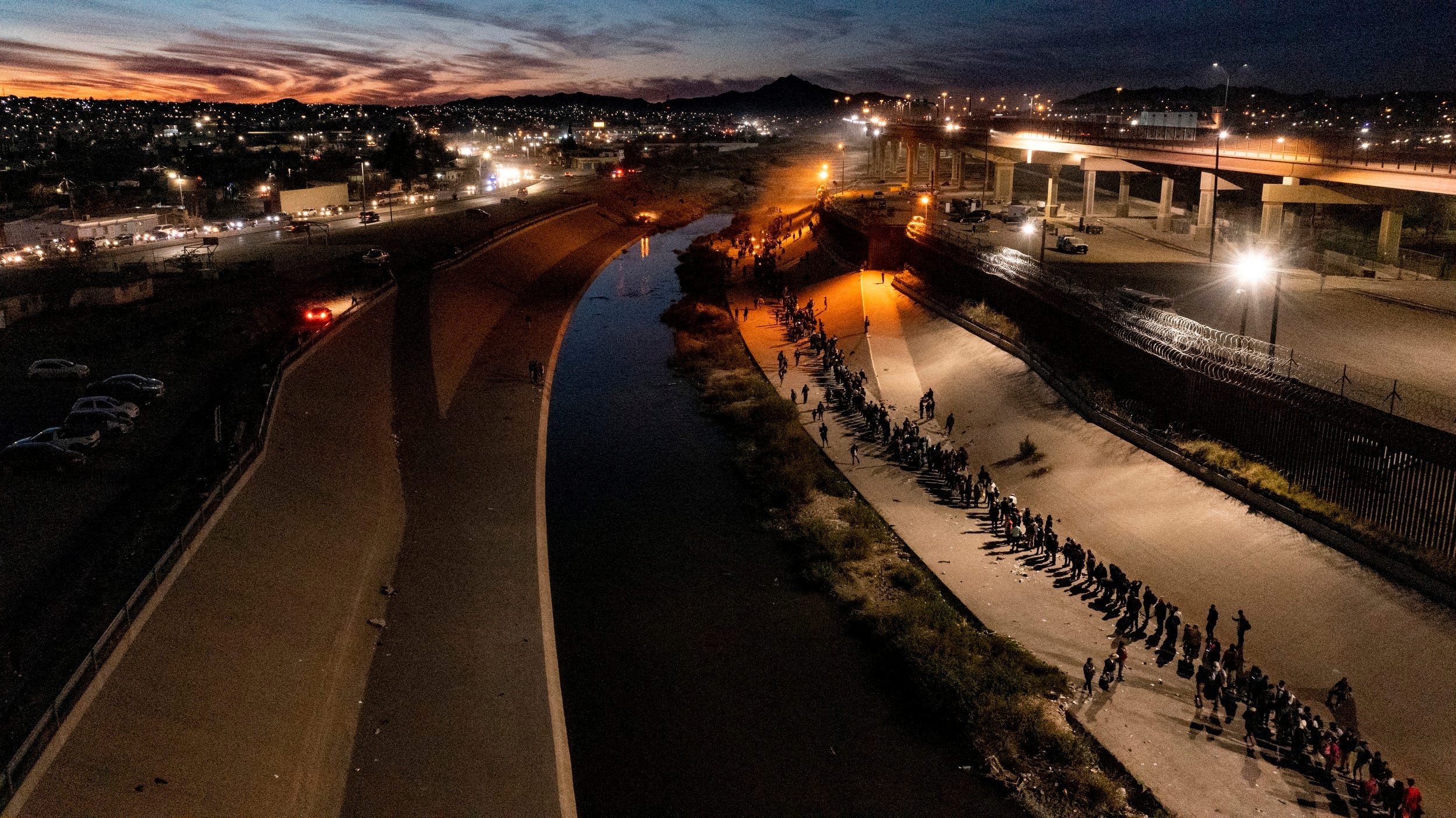 A line of refugees and migrants along the Rio Grande River.