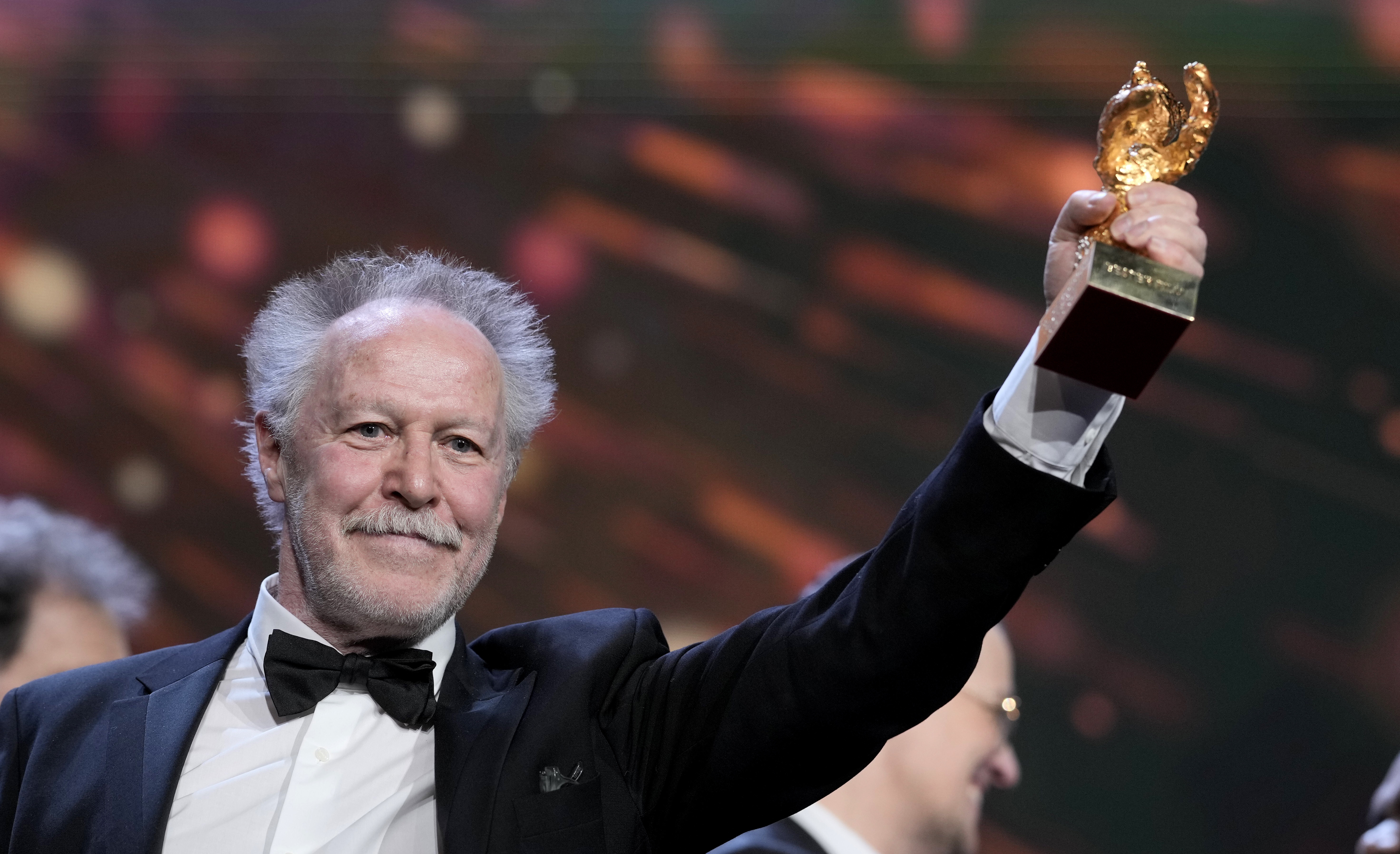 Nicolas Philibert, director of the documentary "On the Adamant" holding the top prize for his documentary film.