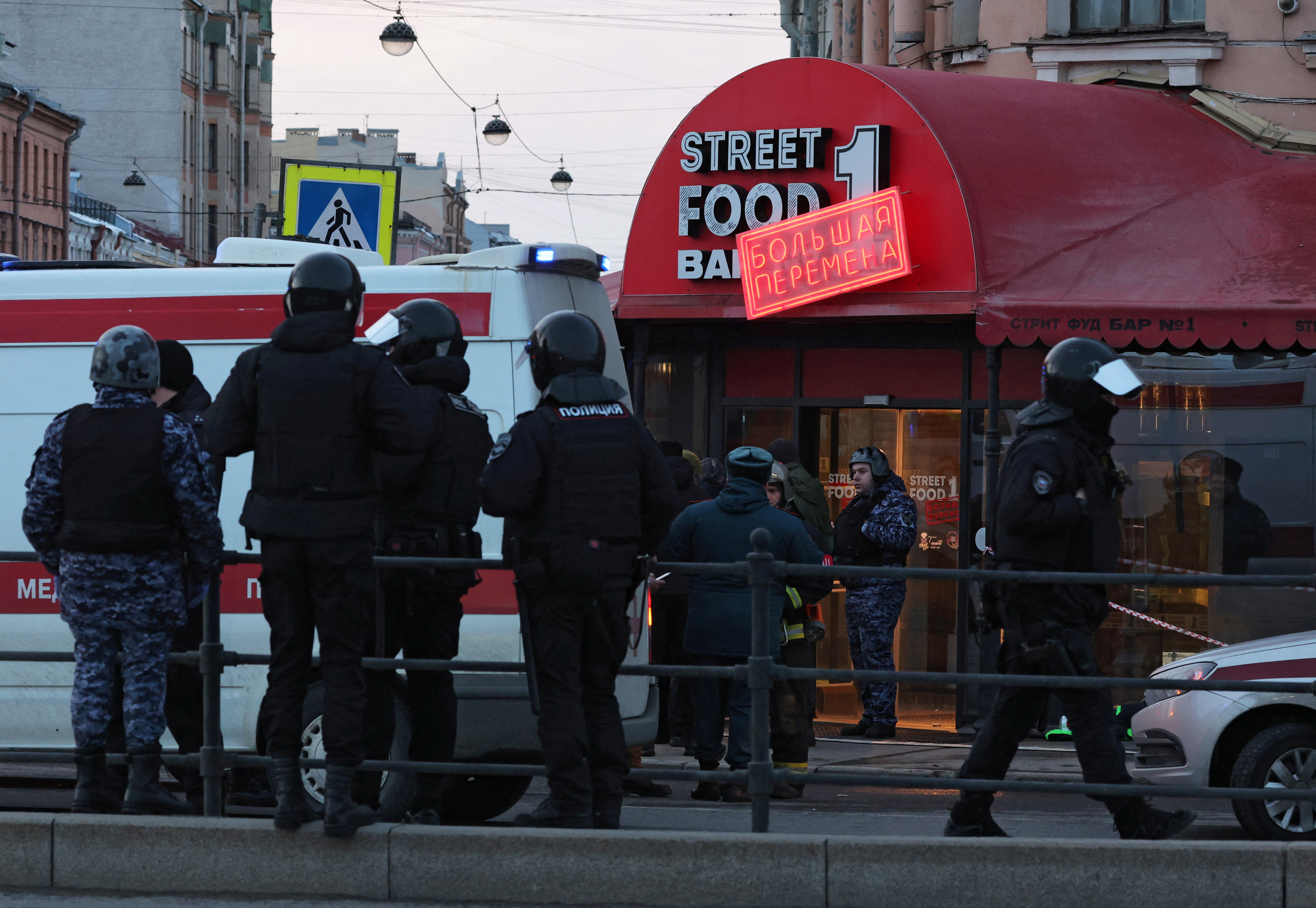 Investigators work at the site of an explosion in a cafe in Saint Petersburg, Russia