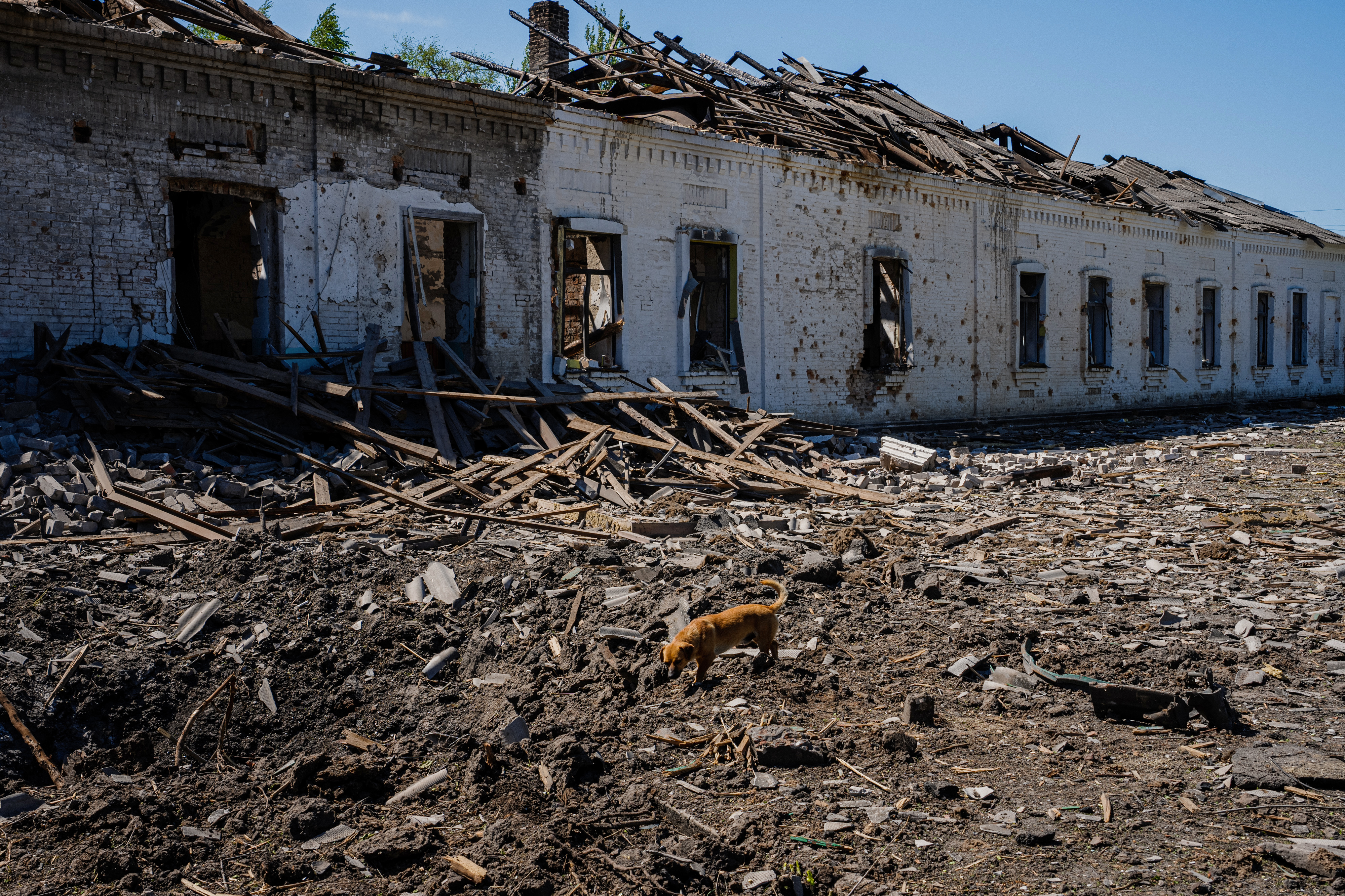 Local residents sit in a volunteer run shelter, providing access to laundry and bathroom facilities where they can warm up, charge their phones, drink hot tea and receive humanitarian aid in the town of Orikhiv, in the Zaporizhzhia region