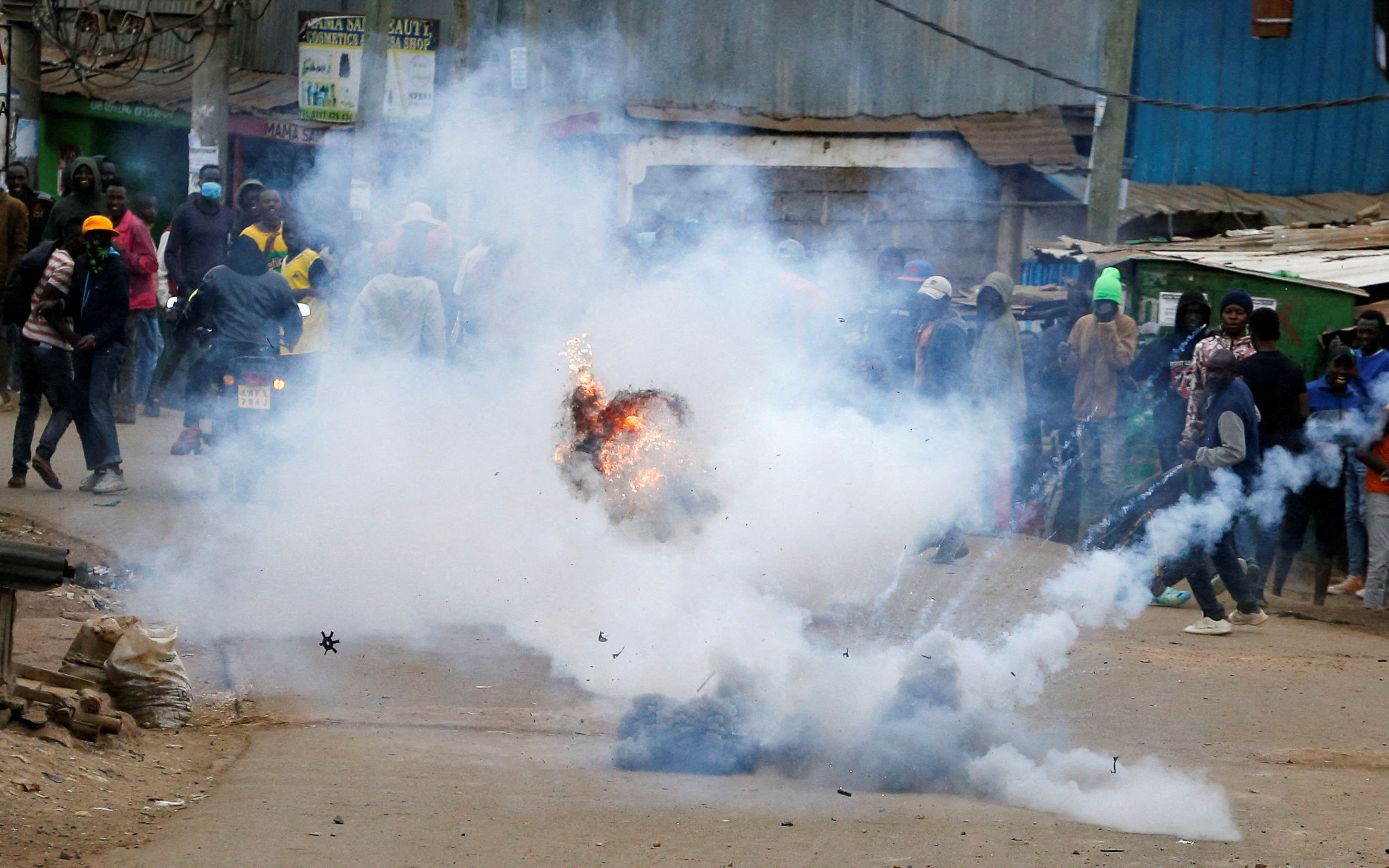A teargas canister, lobbed by riot police officers to disperse protesters, explodes as supporters of Kenya's opposition leader Raila Odinga participate in anti-government protests