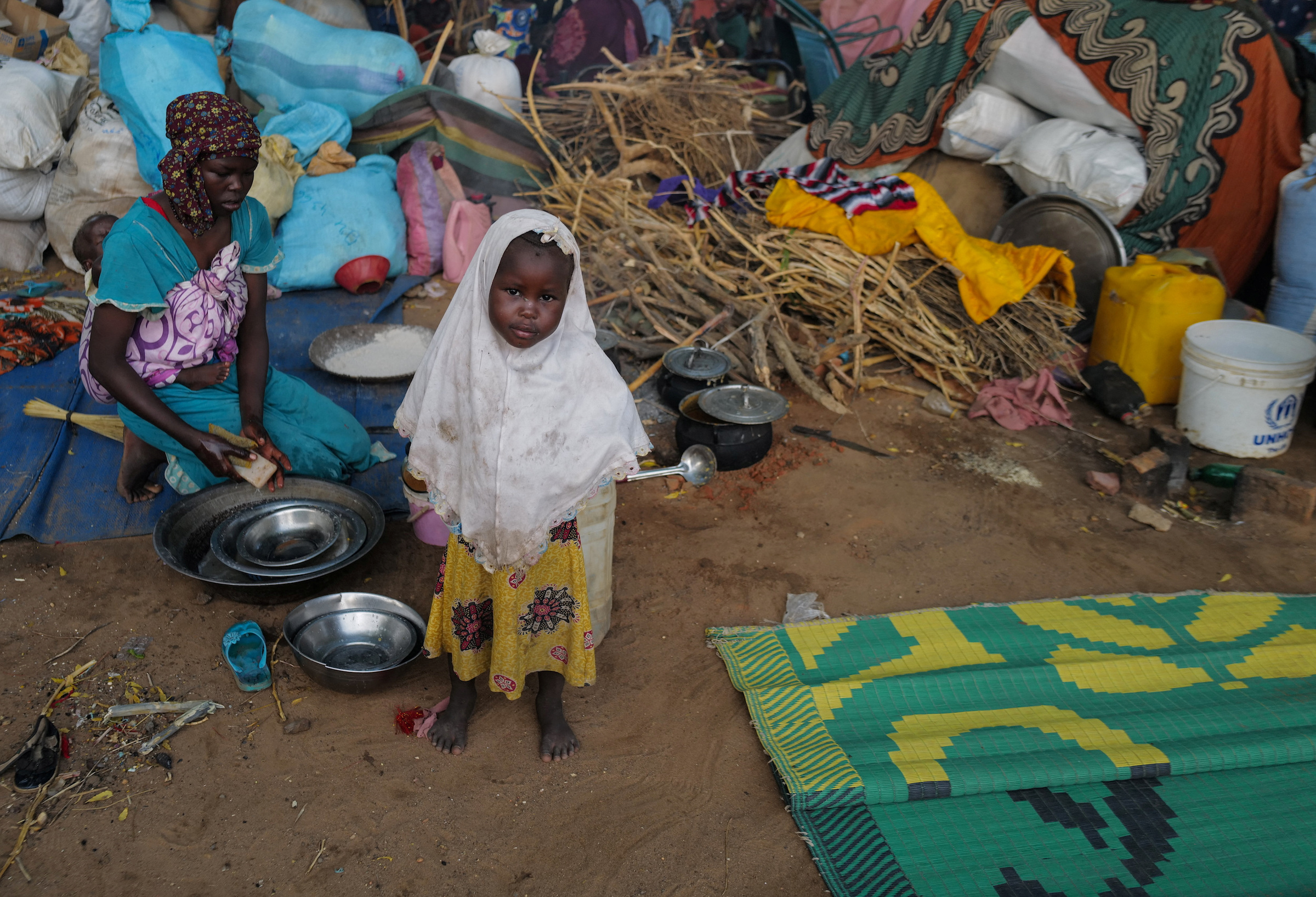 A Sudanese girl, who fled the conflict in Sudan's Darfur region with his family, stands at a temporary shelter in Adre, Chad.