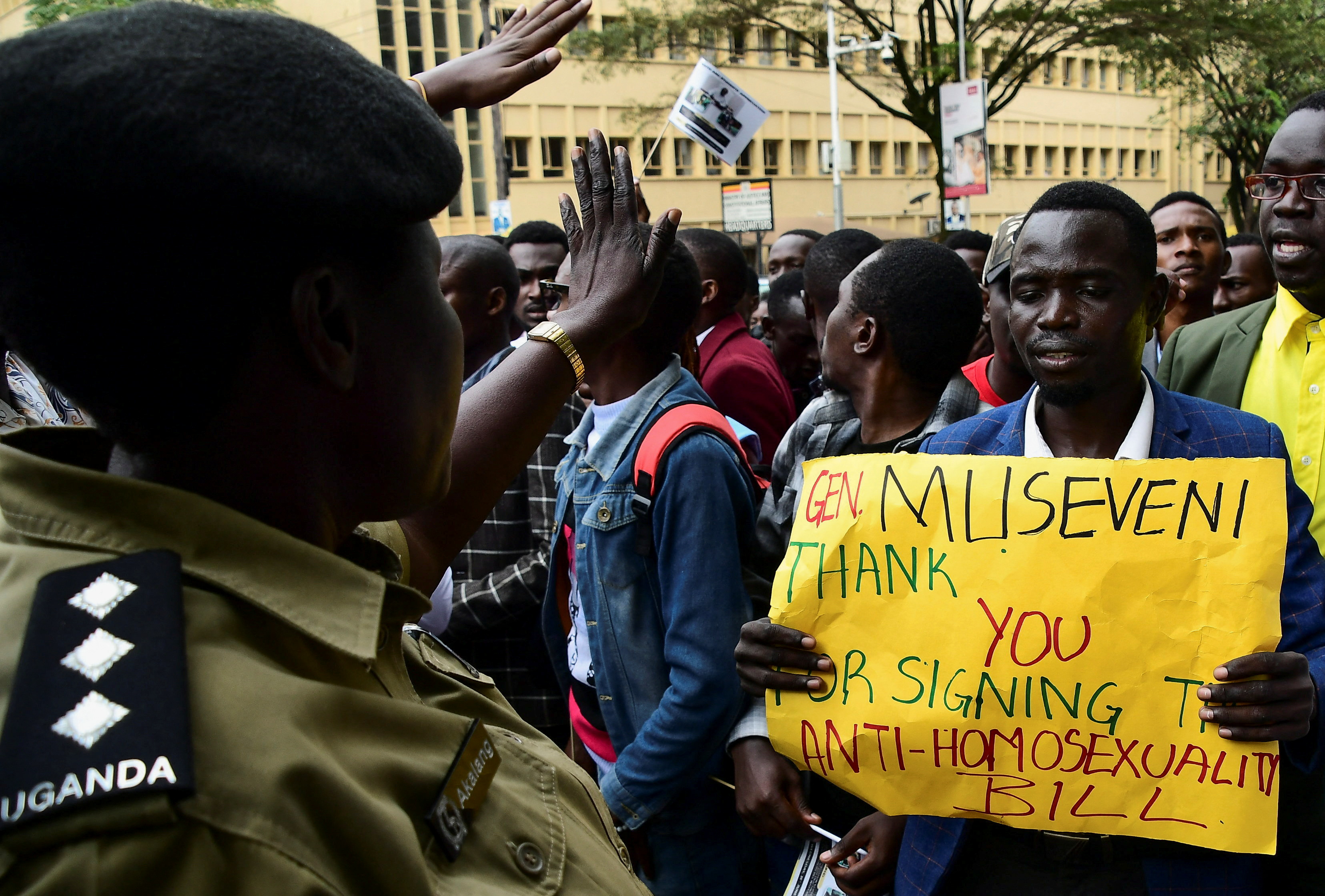 A Ugandan police officer directs students as they participate in a peaceful walk to appreciate President Yoweri Museveni