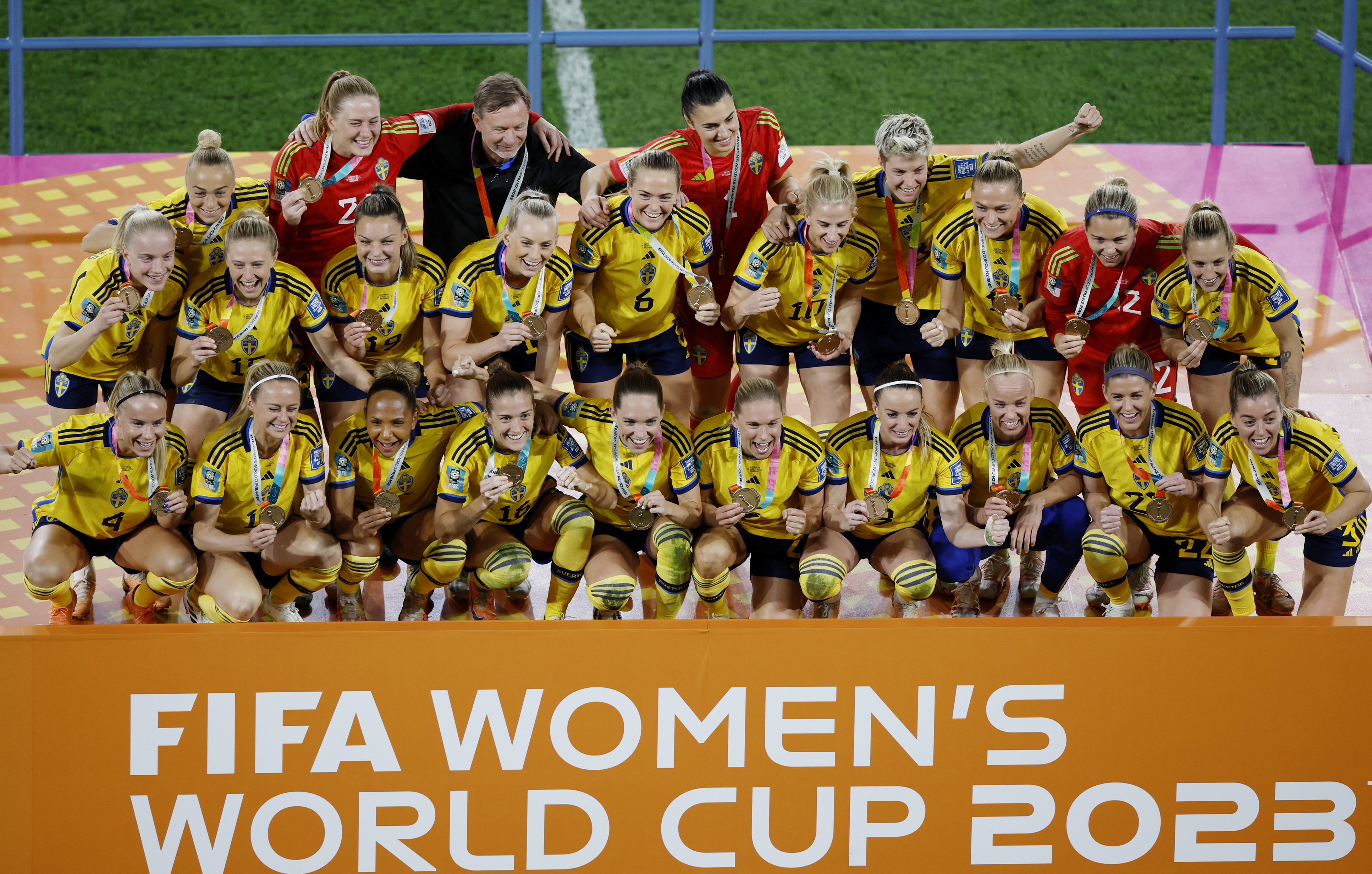 Sweden pose on the stage after receiving their third-place medals