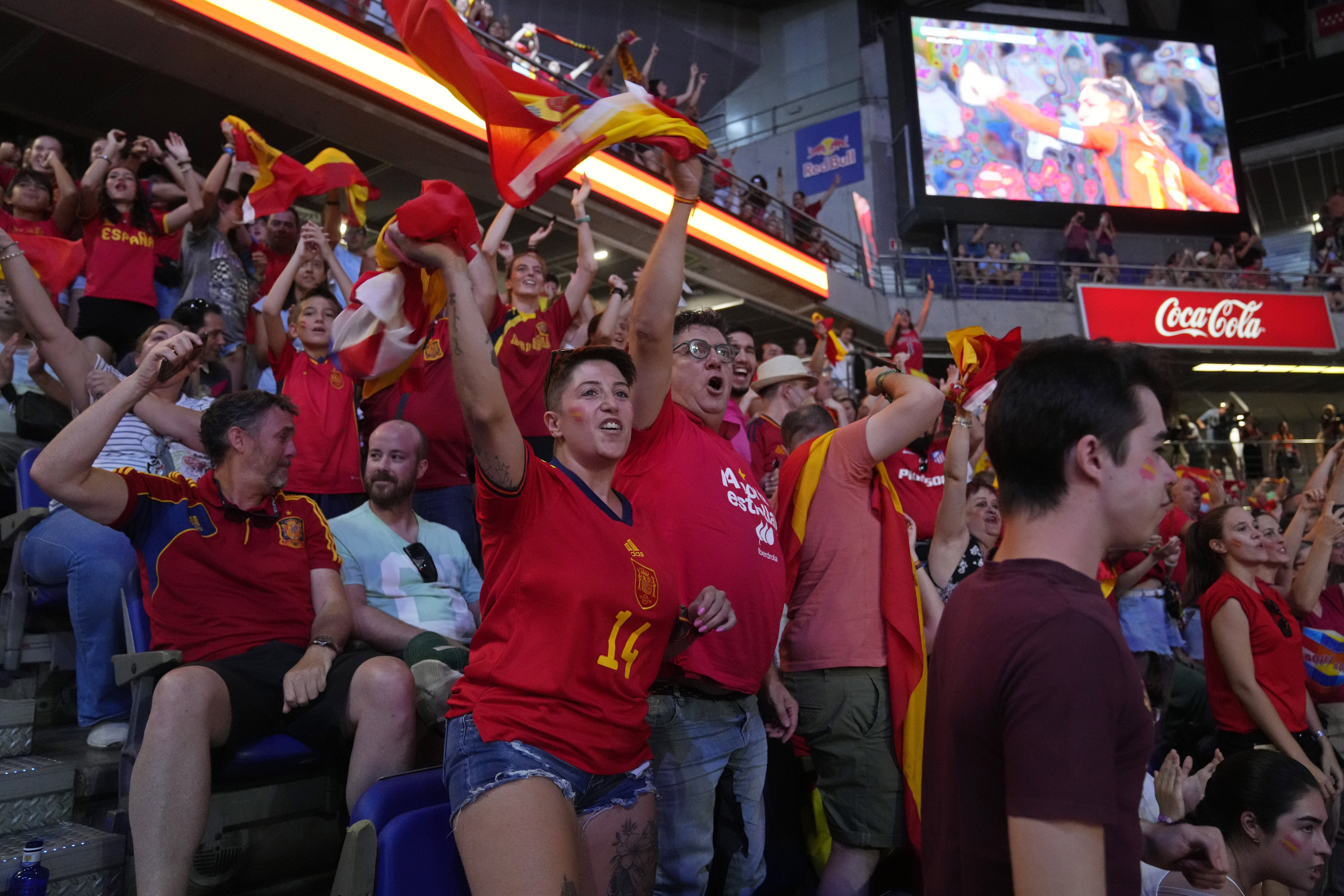Spanish fans cheer in front of large screens after Spain's Olga Carmona scored the opening goal during the Women's World Cup final soccer match between Spain and England in Madrid, Spain, Sunday, Aug. 20, 2023