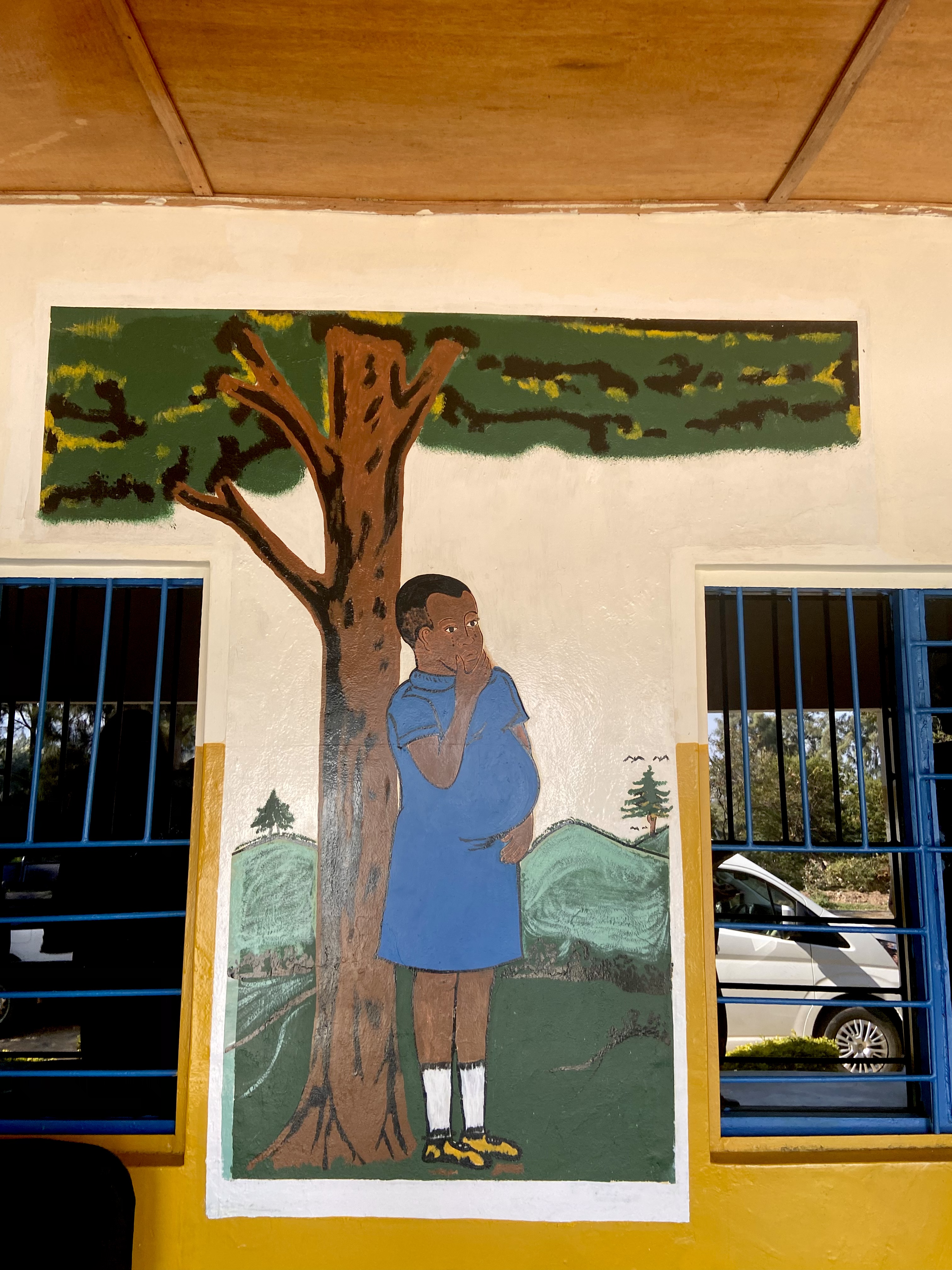 Artwork depicting a pregnant Rwandan teen outside the community center in Karongi district of Rwanda 