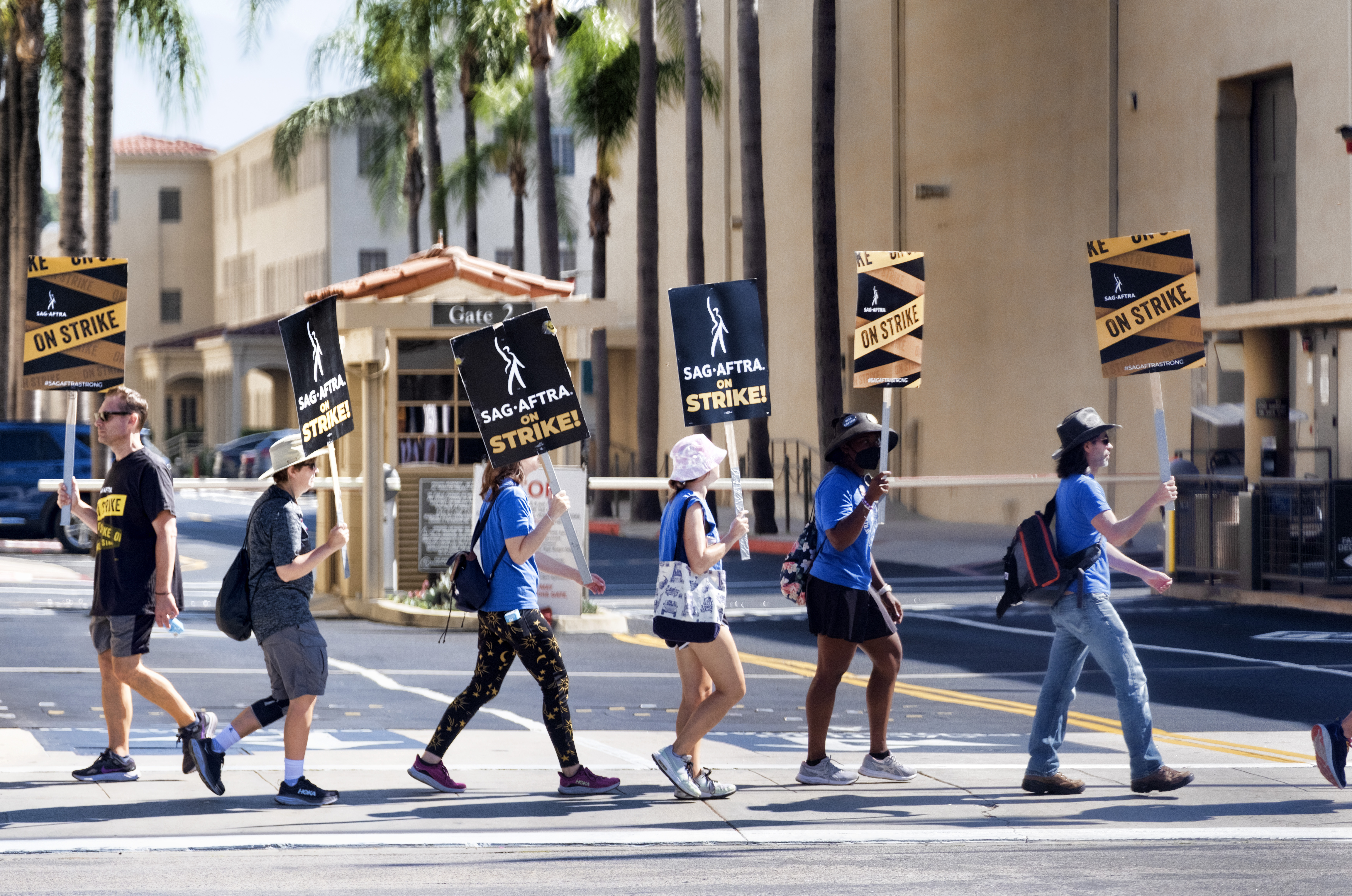 Screenwriters join members of SAG-AFTRA, the main Hollywood actors’ union, outside the gates of Warner Brothers studios in Burbank, California