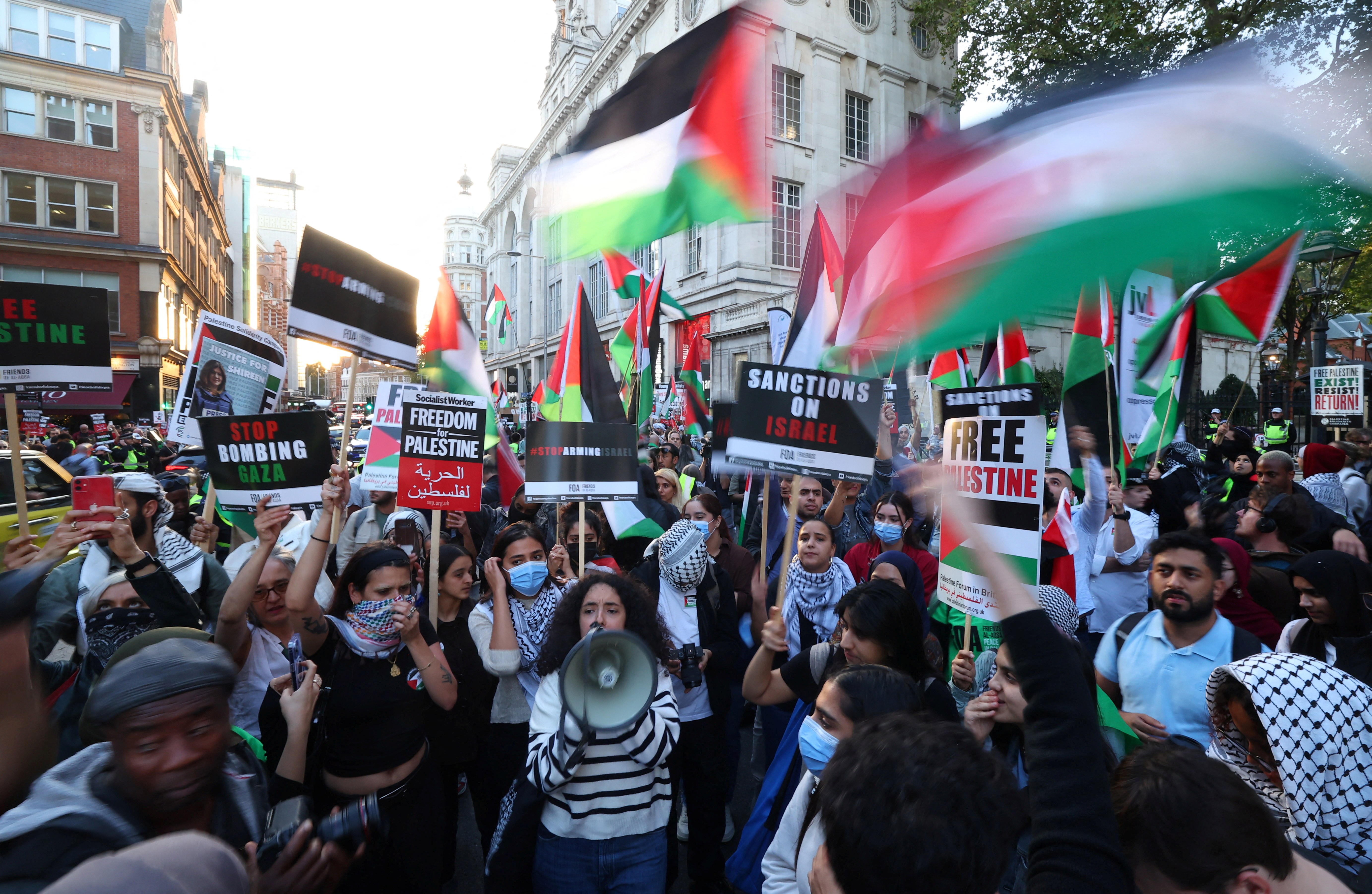 Pro-Palestinian demonstrators protest during the ongoing conflict between Israel and the Palestinian Islamist group Hamas, near the Israeli embassy in London, Britain