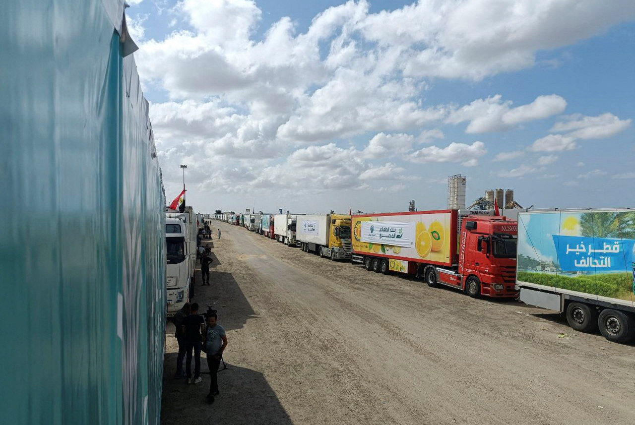 Trucks carrying humanitarian aid from Egyptian NGOs for Palestinians wait for the reopening of the Rafah crossing at the Egyptian side, to enter Gaza