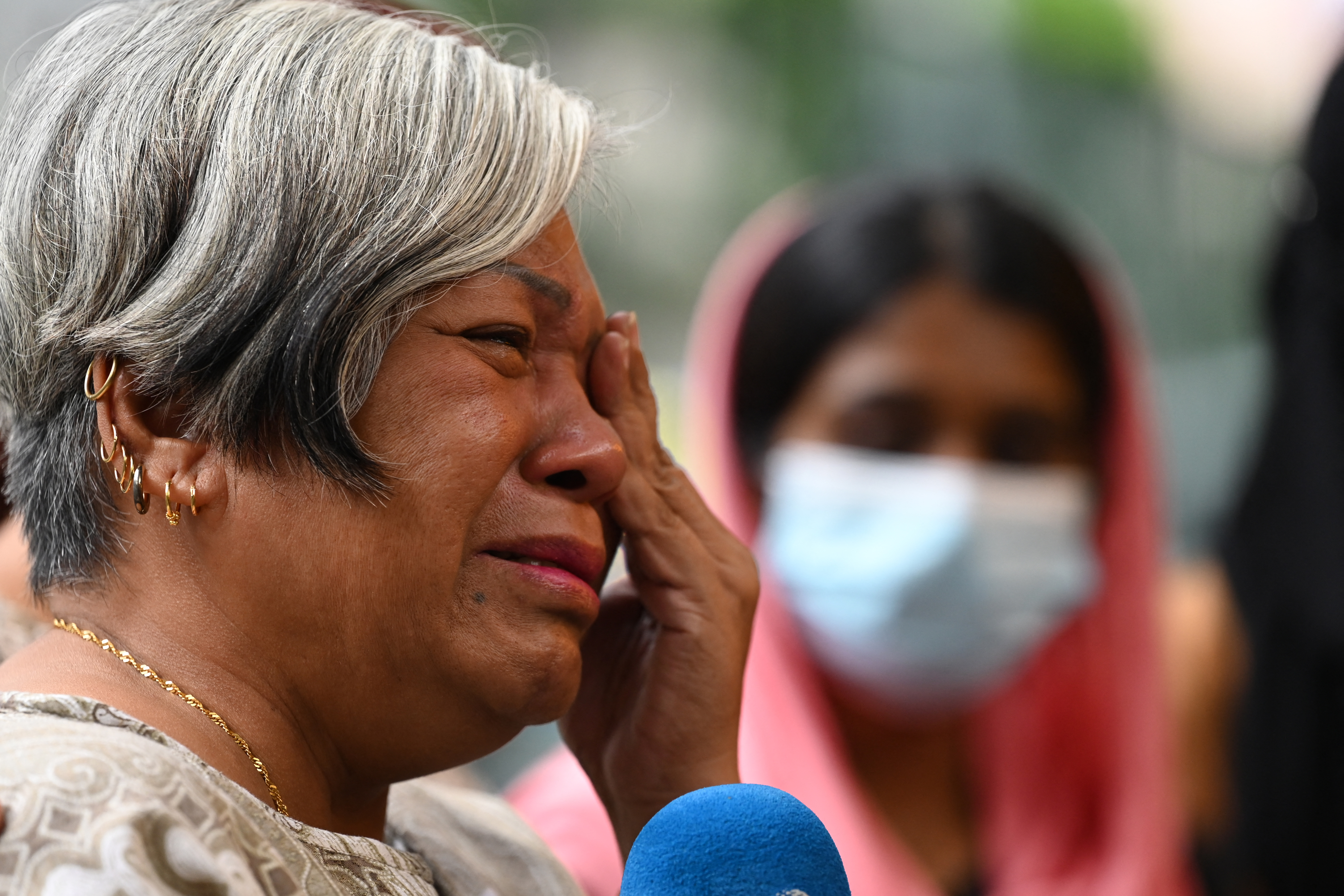 Halinda Binte Ismail, mother of death row convict Mohd Idzwan cries as she speaks to reporters.