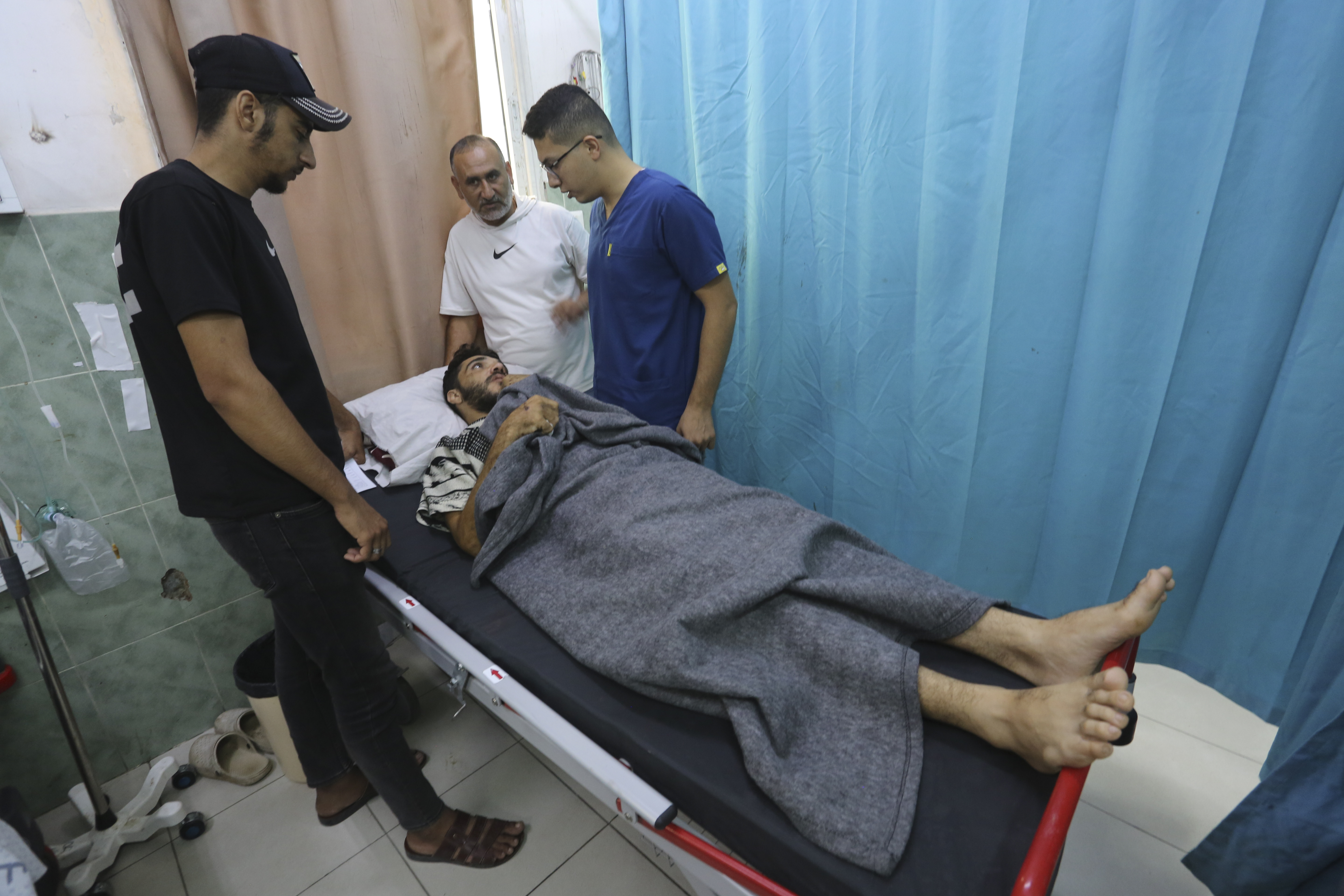 A Palestinian wounded in the Israeli bombardment of the Gaza Strip waits for treatment in a hospital in Rafah