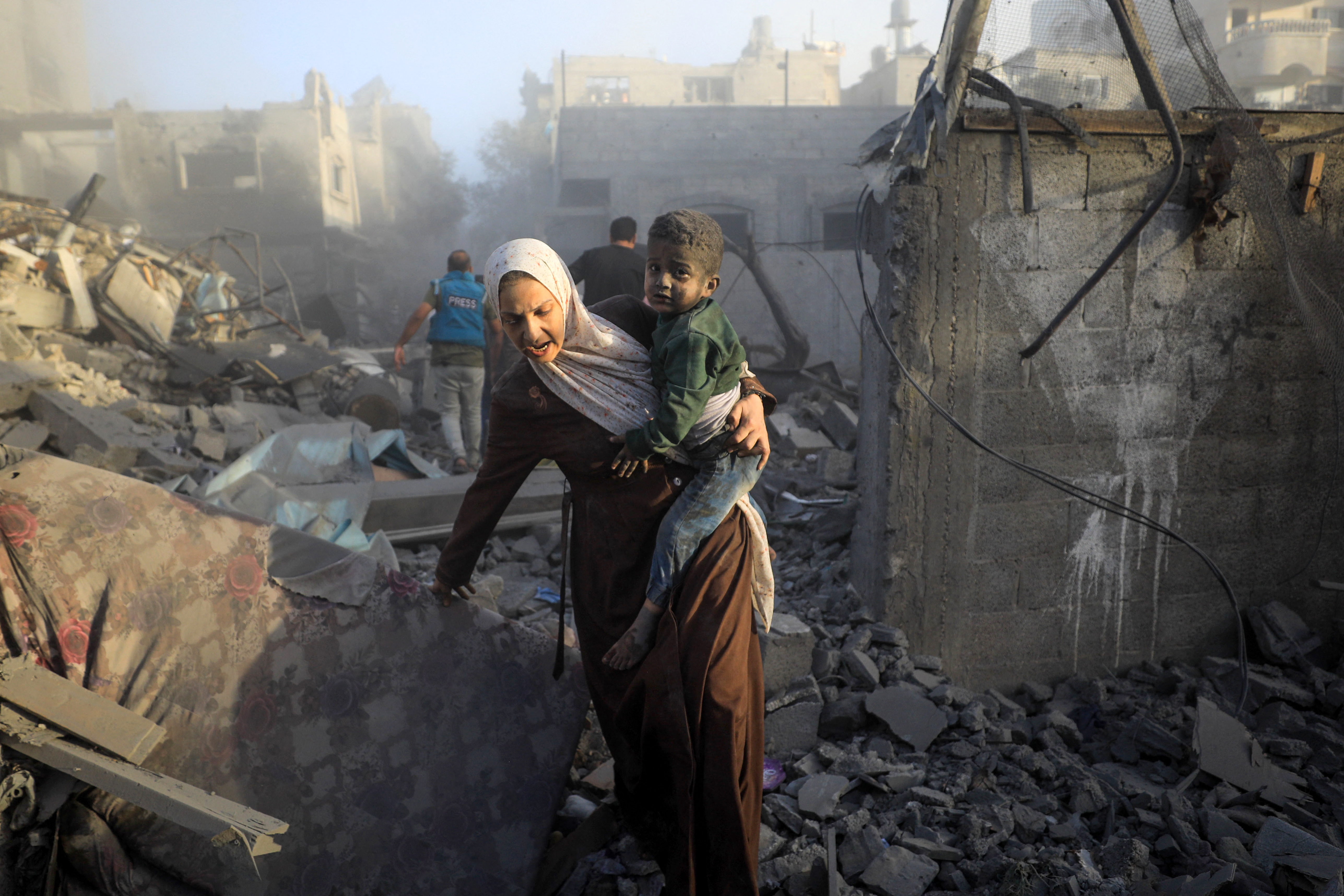 People flee following Israeli air strikes on a neighbourhood in the al-Maghazi refugee camp in the central Gaza Strip on November 6,