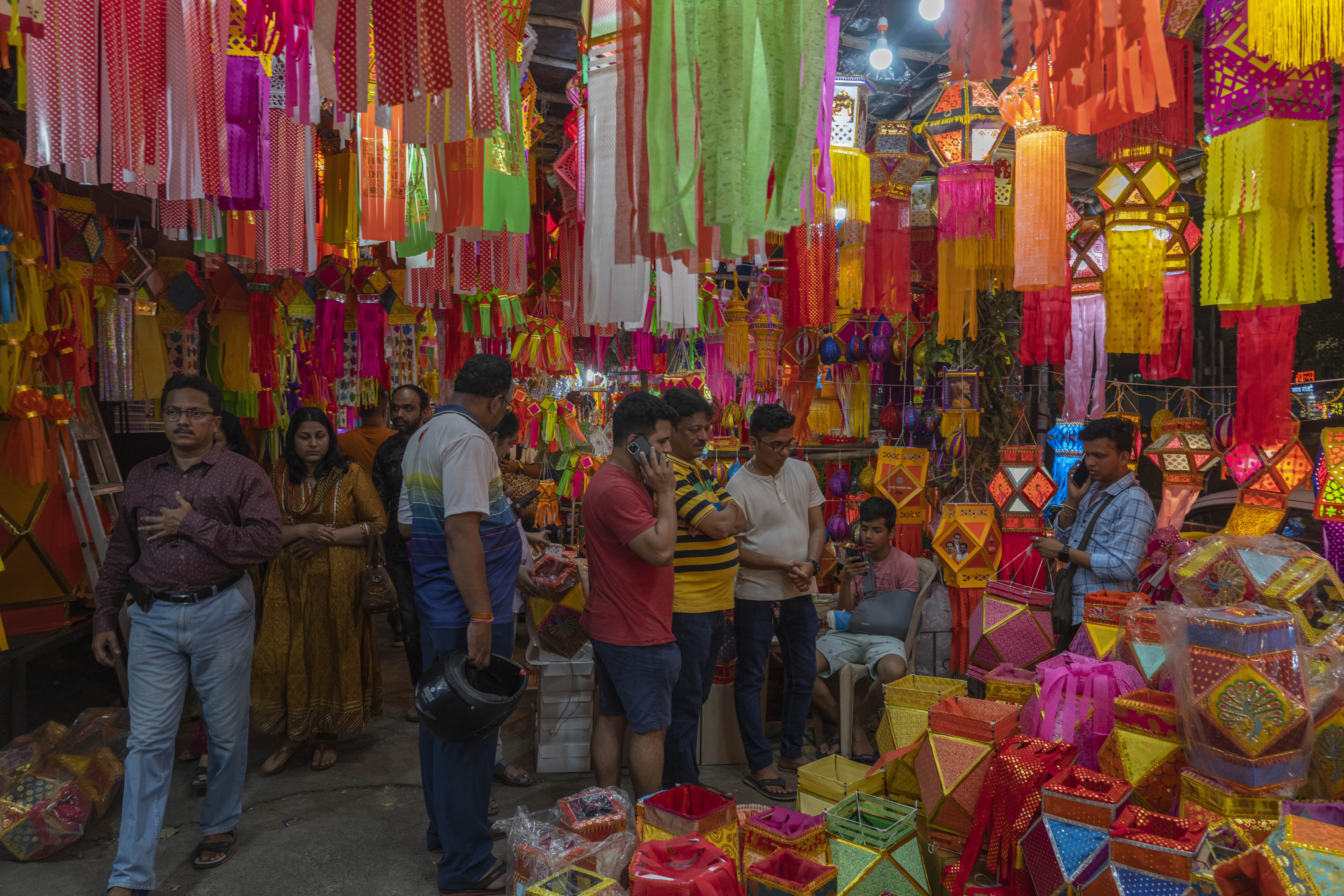 People look at lanterns displayed for sale at roadside stalls ahead of Diwali festival in Mumbai, India, 