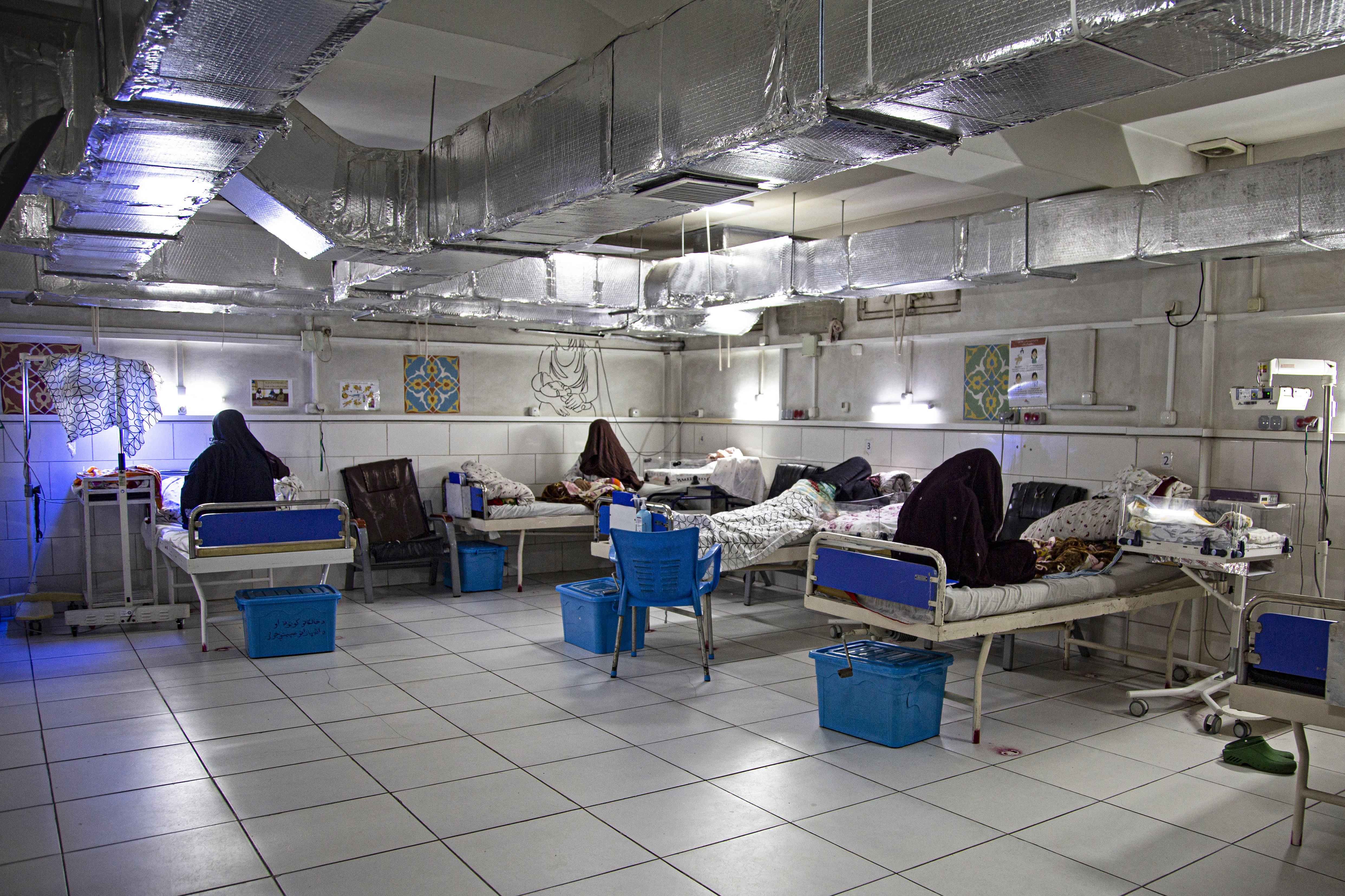 In this photograph taken on December 8, 2023, Afghan women sit beside their newborns at the Doctors Without Borders (MSF)-run maternity hospital in Khost.