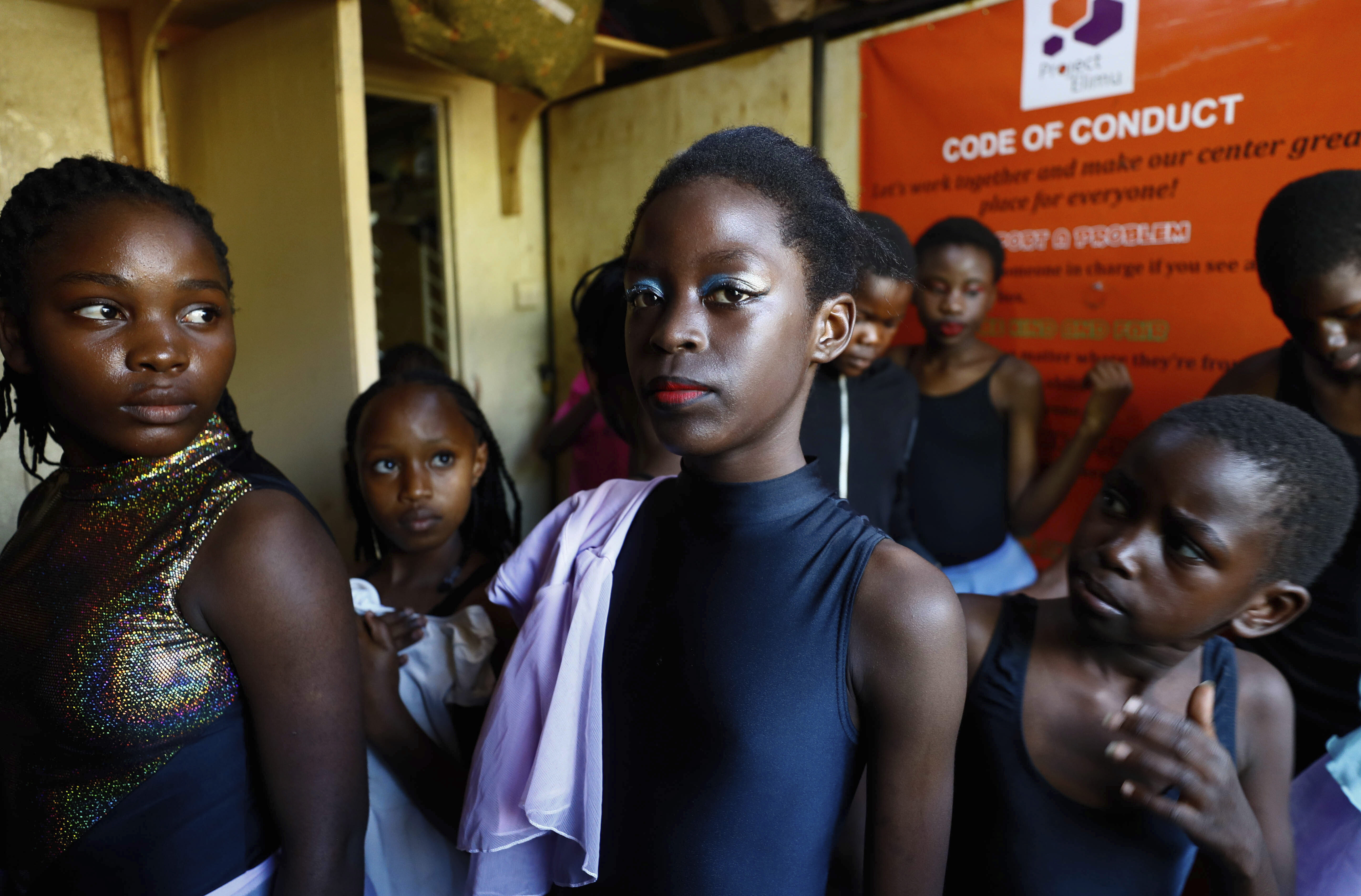 Young girls get their makeup applied at