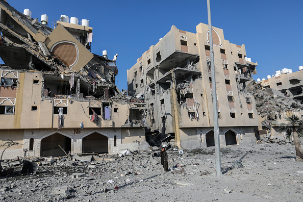Palestinian citizens inspect the destruction caused by air strikes on their homes on December 02, 2023 in Khan Yunis, Gaza.