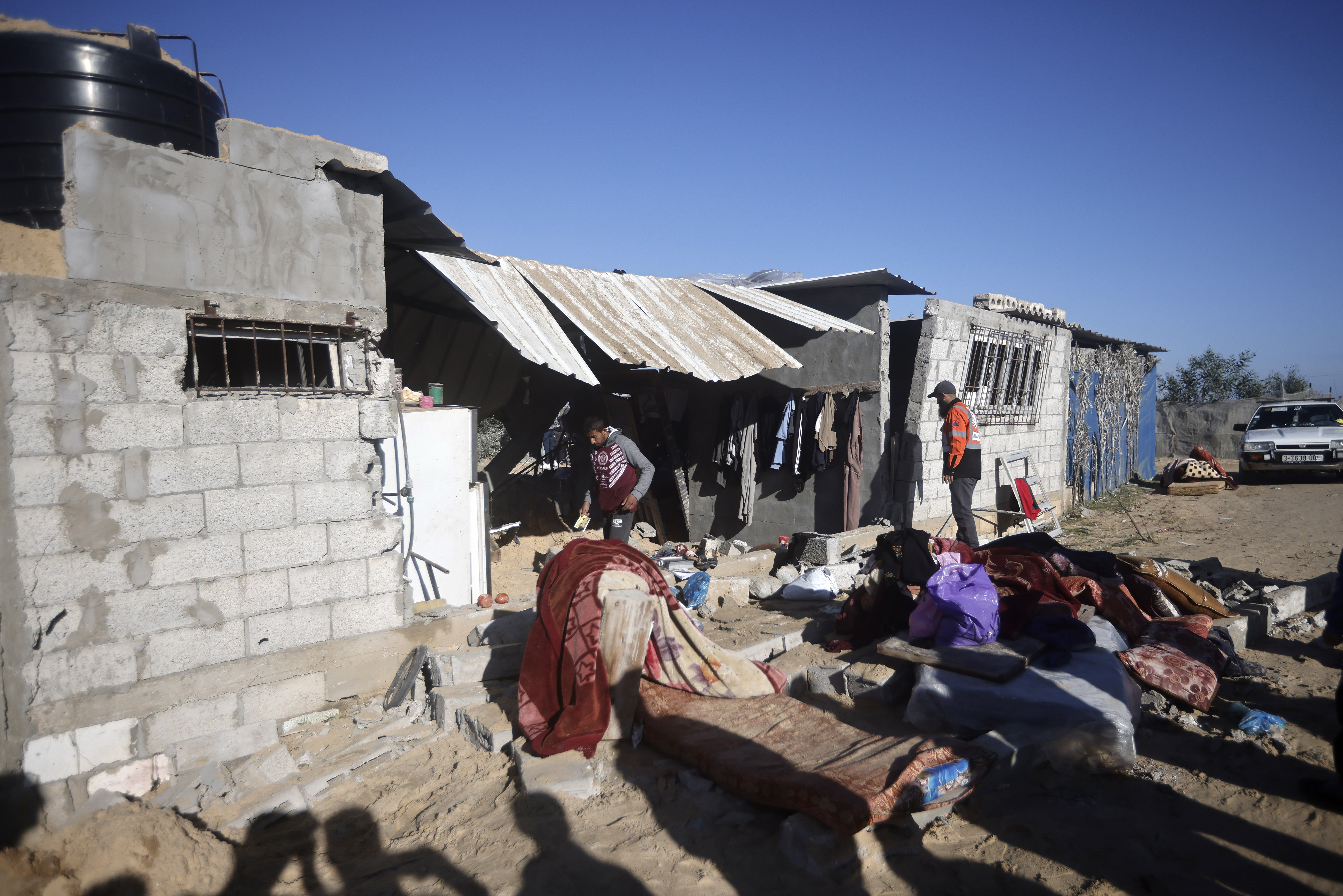 Palestinians salvage what they can from their belongings following Israeli airstrikes on Khan Younis, Gaza Strip.