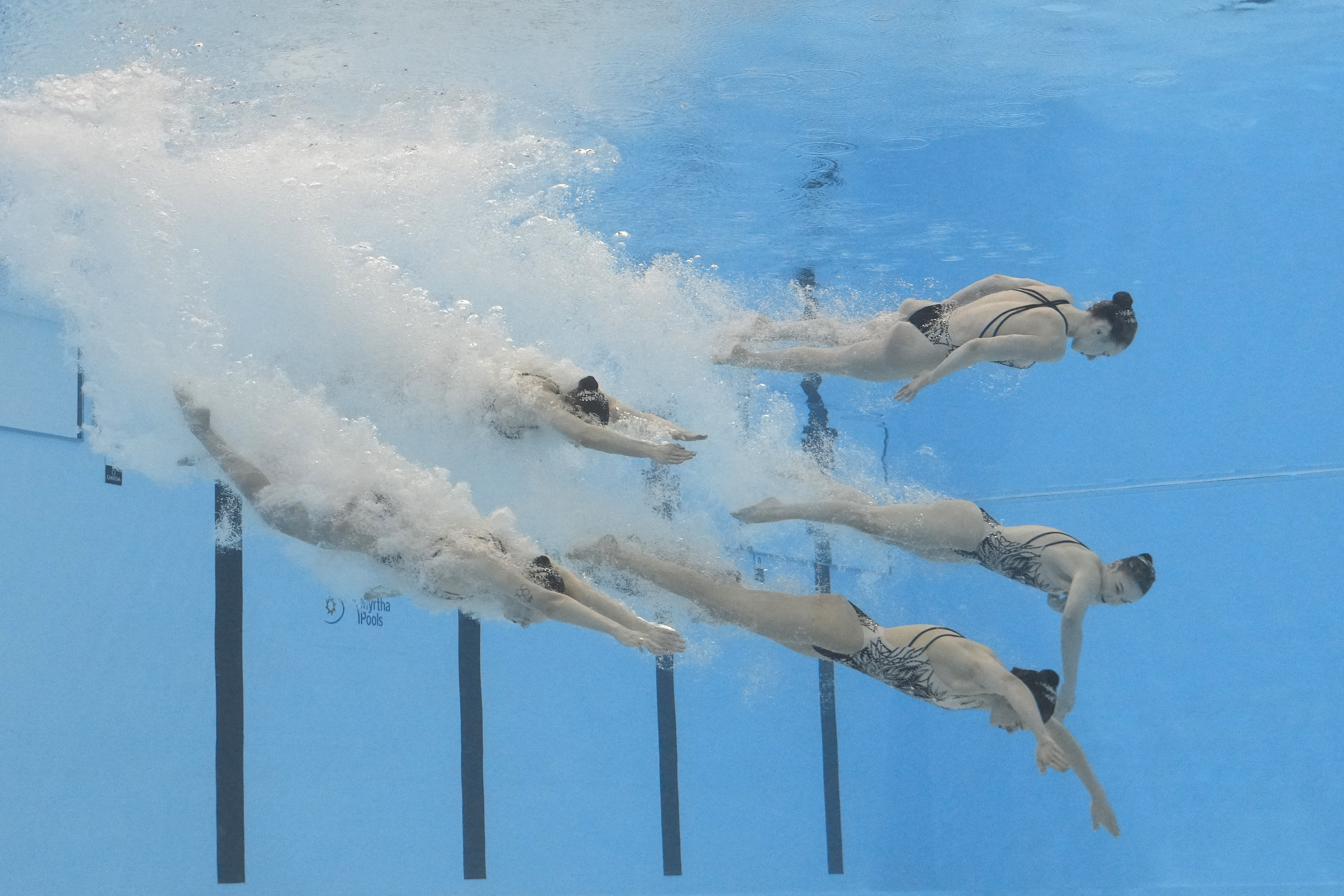 Ukraine team compete in the mixed team acrobatic final of artistic swimming at the World Aquatics Championships in Doha, Qatar, Sunday, Feb. 4