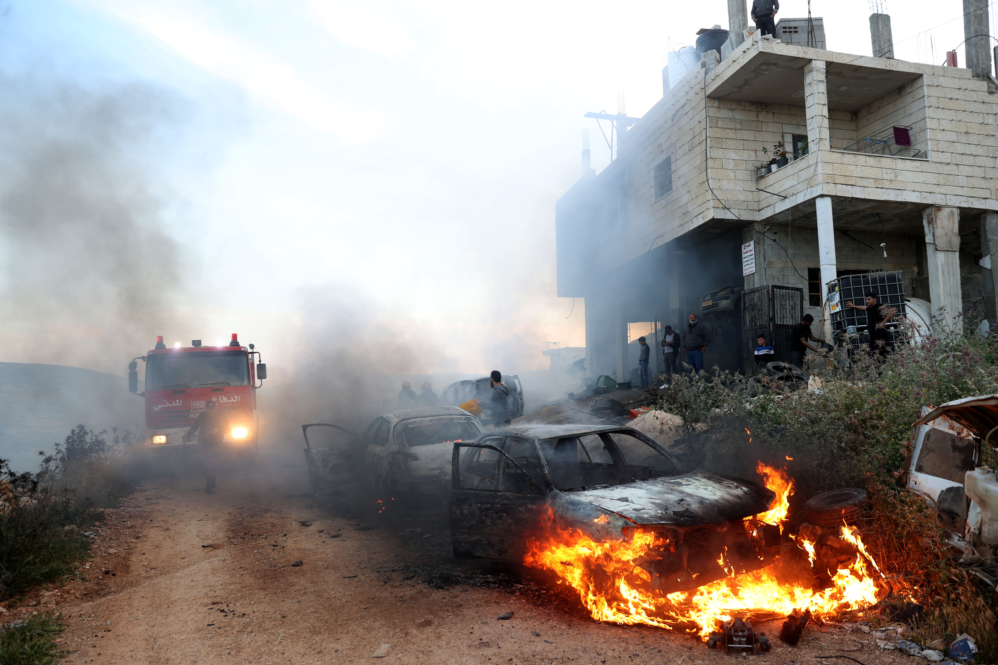 A view of damaged houses and burning vehicles after a raid by Jewish settlers on the Mughir town near Ramallah. [Anadolu]