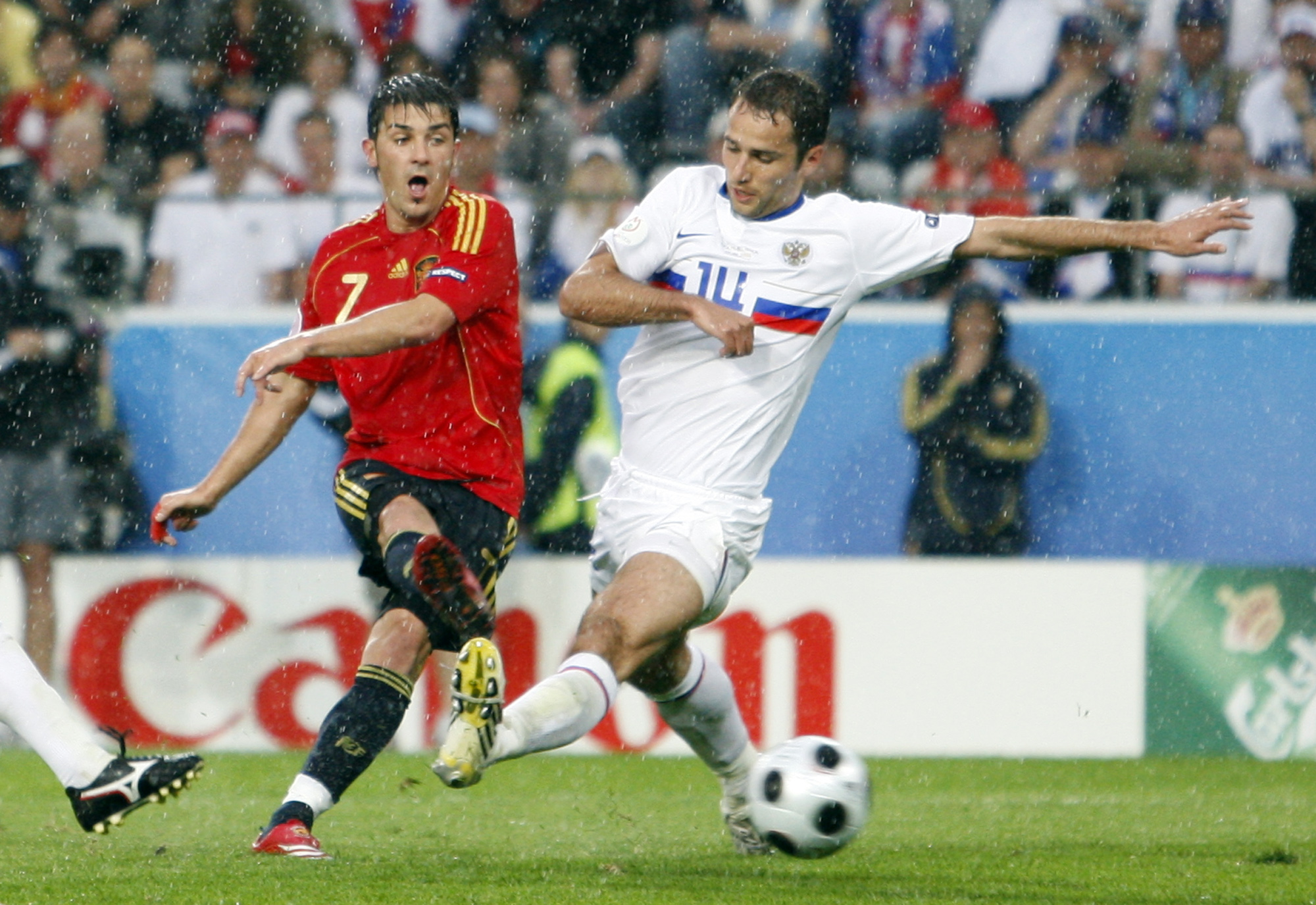 Football player kicks goal.