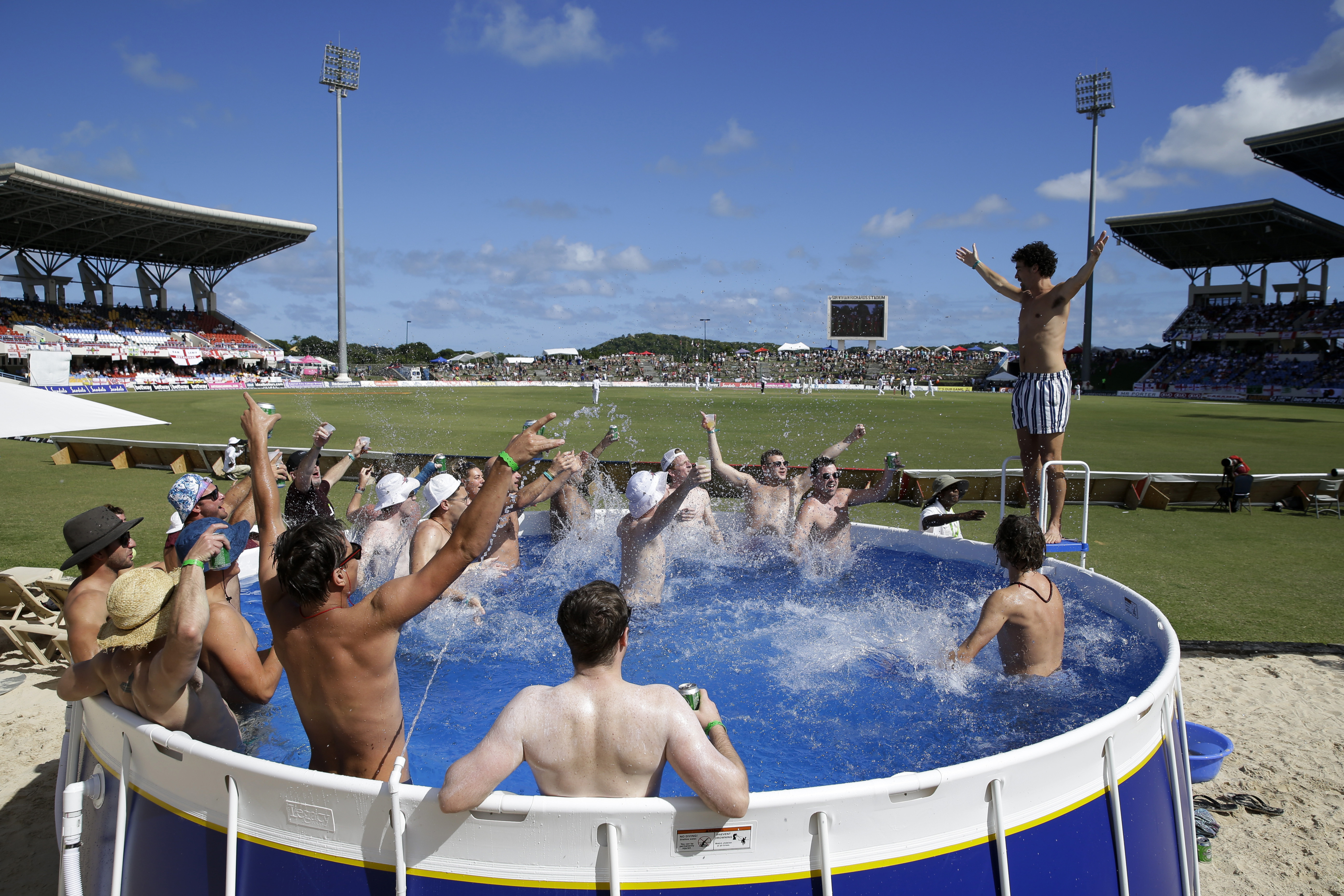 England cricket fans watch day one of the second Test cricket match against the West Indies from a pool at the Sir Vivian Richards Stadium in North Sound, Antigua and Barbuda, on January 31, 2019