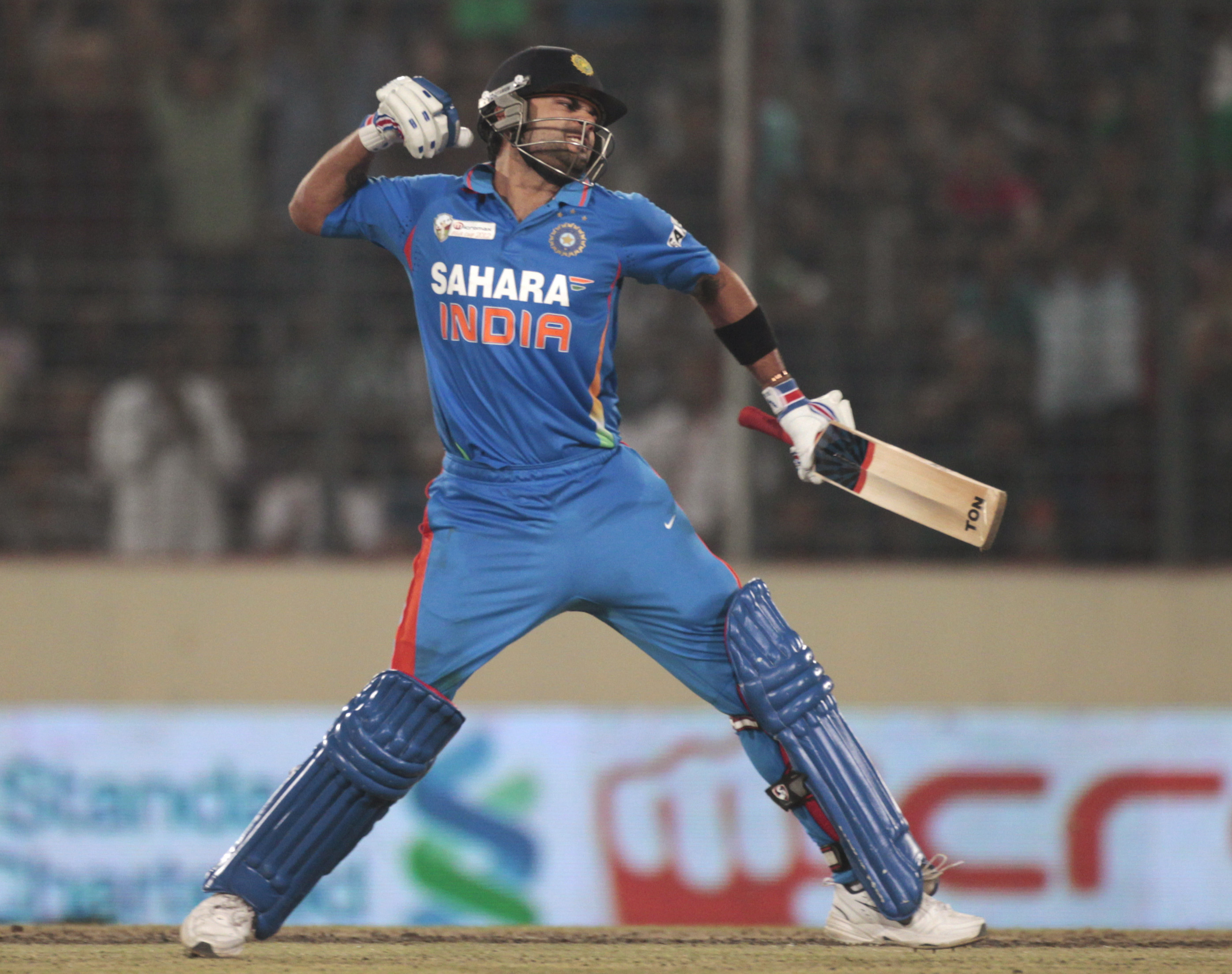 India's Virat Kohli celebrates after scoring a century against Pakistan during their Asia Cup One Day International cricket match in Dhaka March 18, 2012. REUTERS/Andrew Biraj (BANGLADESH - Tags: SPORT CRICKET)