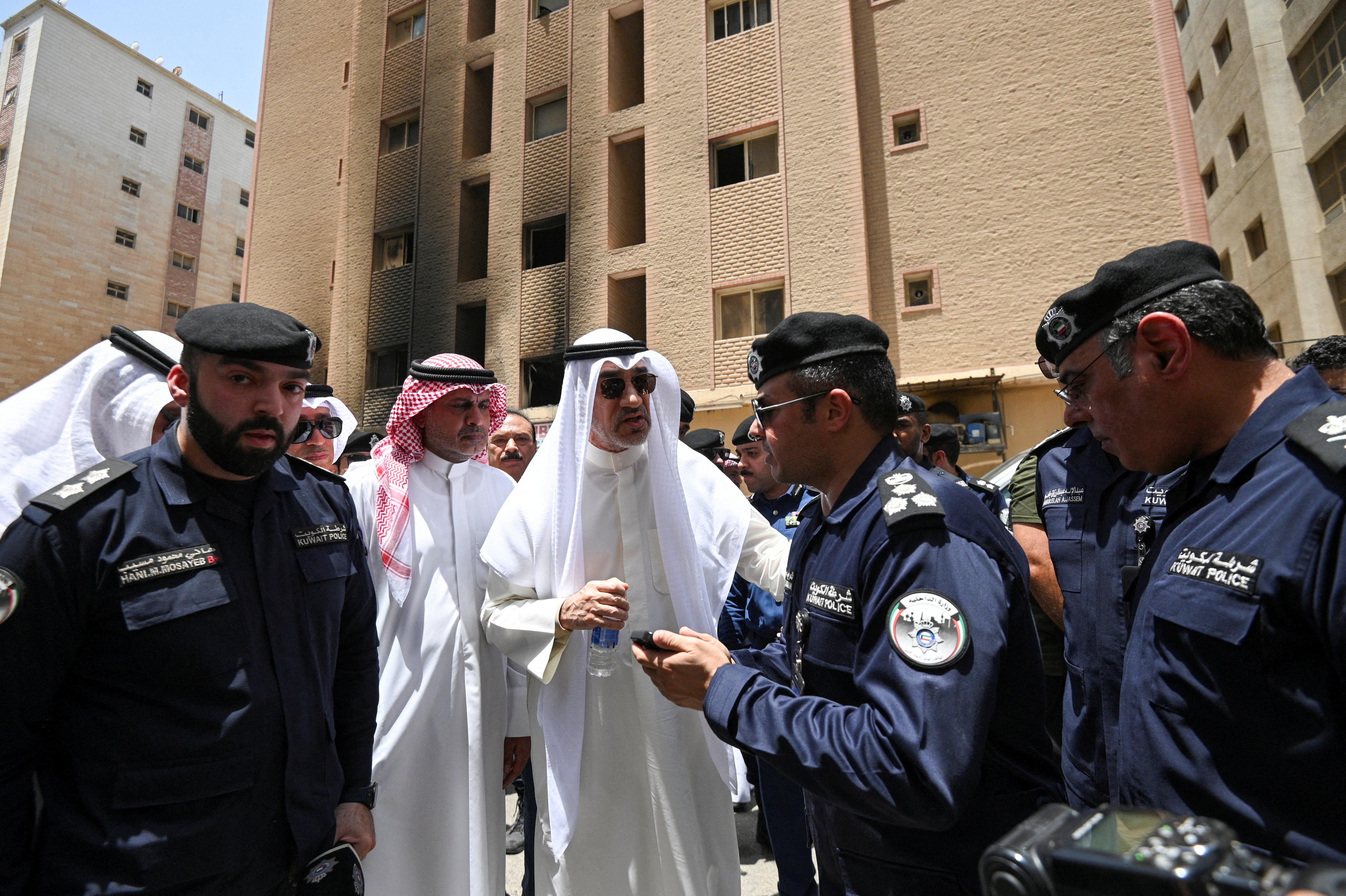 Deputy Prime Minister Sheikh Fahad al-Yousuf al-Sabah speaks with police officers at the site [Reuters]