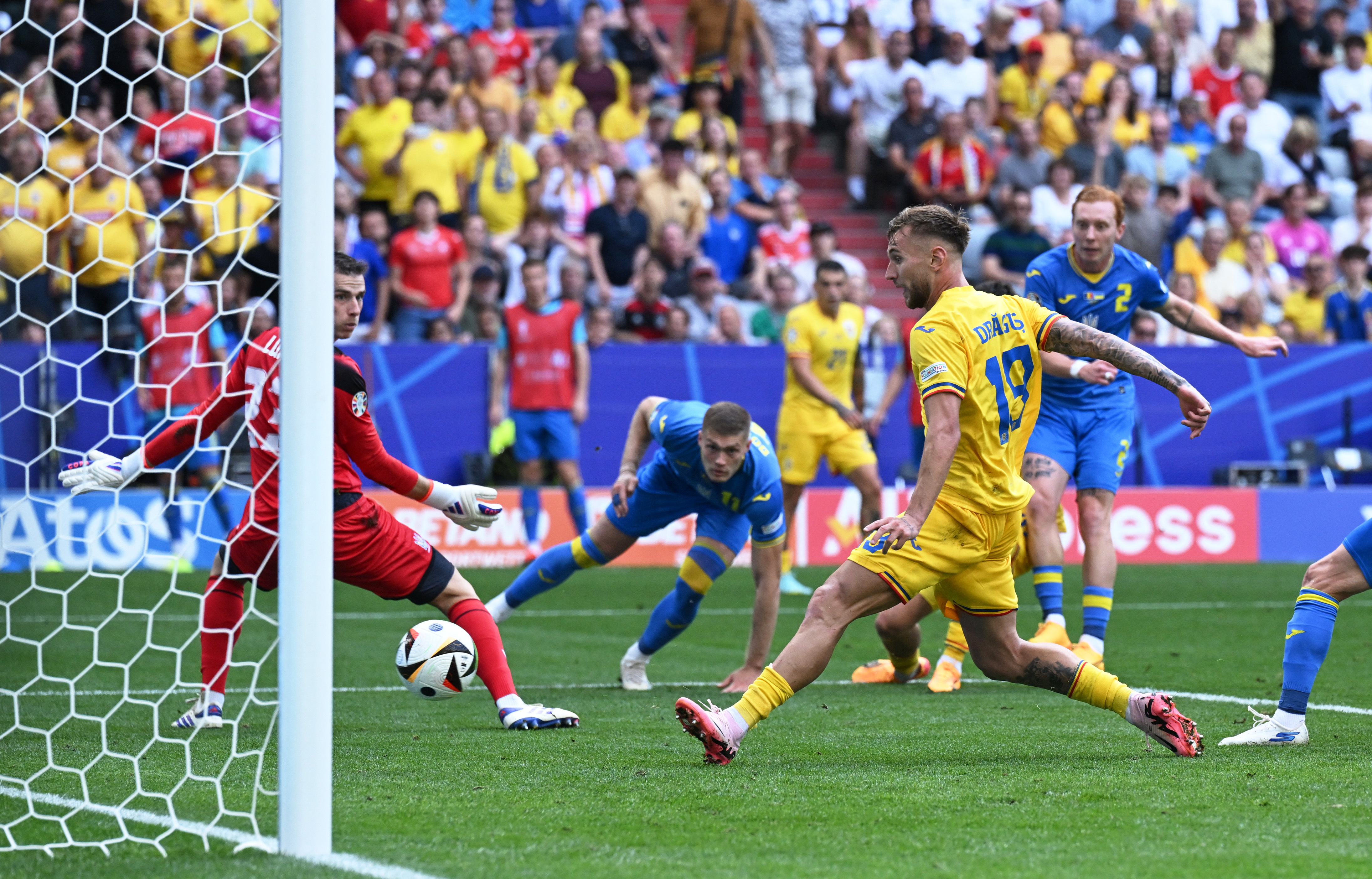 Romania’s Denis Dragus scores the team’s third goal against Ukraine at Euro 2024