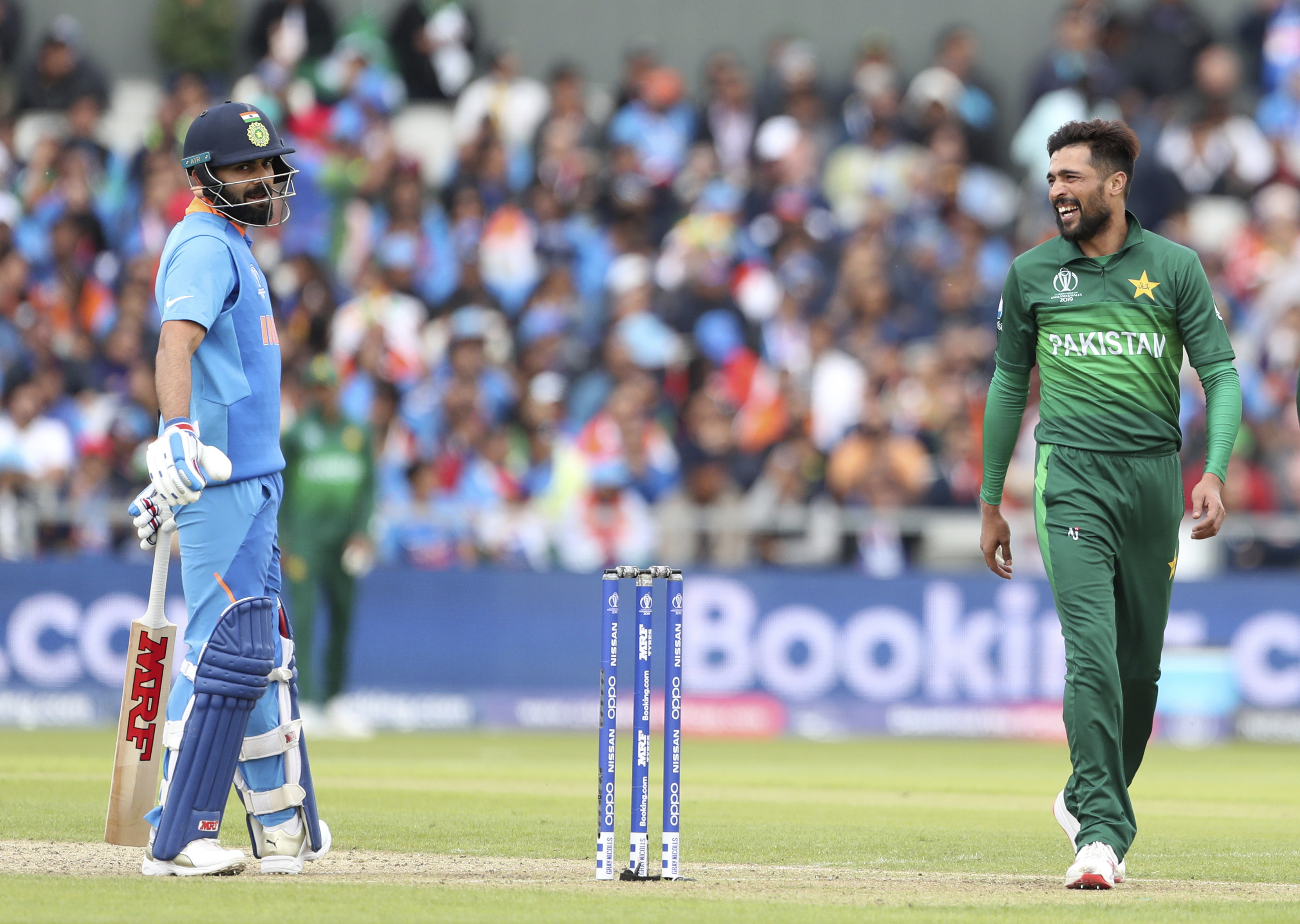 Mohammad Amir and Virat Kohli share a light moment during India and Pakistan’s match at the ICC Cricket World Cup 2019