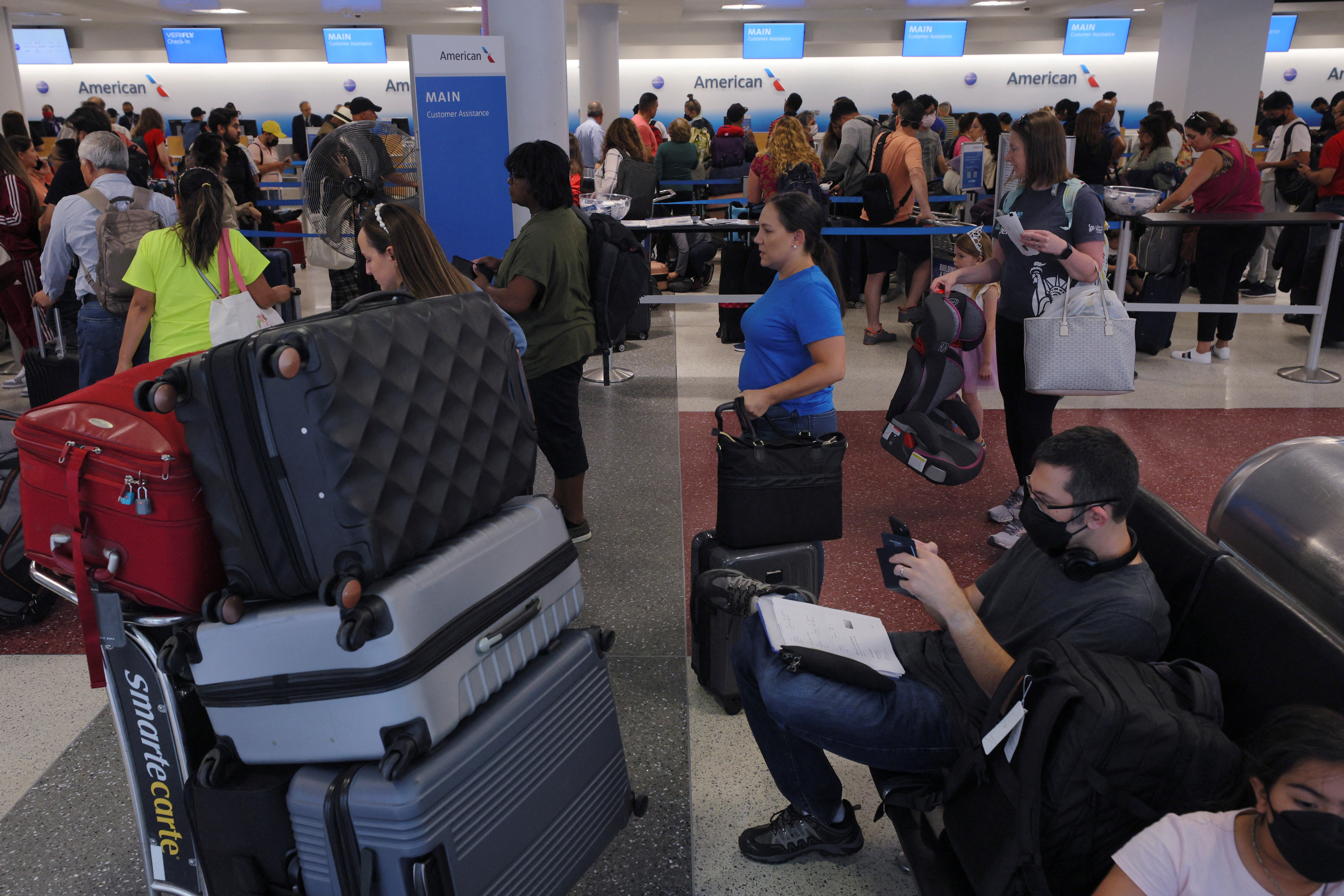 Travellers line up at the American Airlines counters in Logan Airport at the start of the long July 4th holiday weekend in Boston, Massachusetts, US