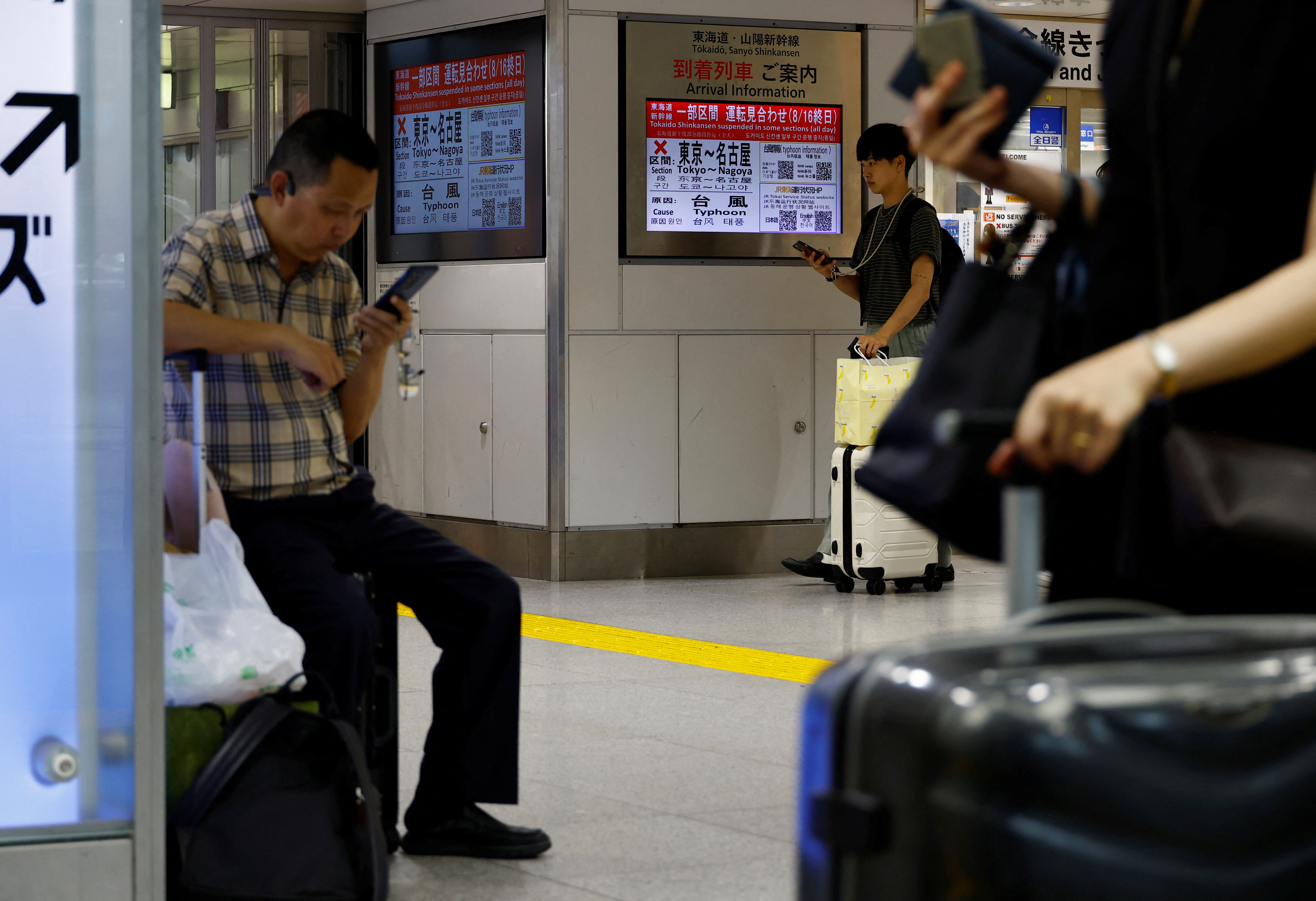A monitor displays a cancellation alert for bullet train services between Tokyo and Nagoya due to Typhoon Ampil, at a station in Tokyo, Japan, on August 16