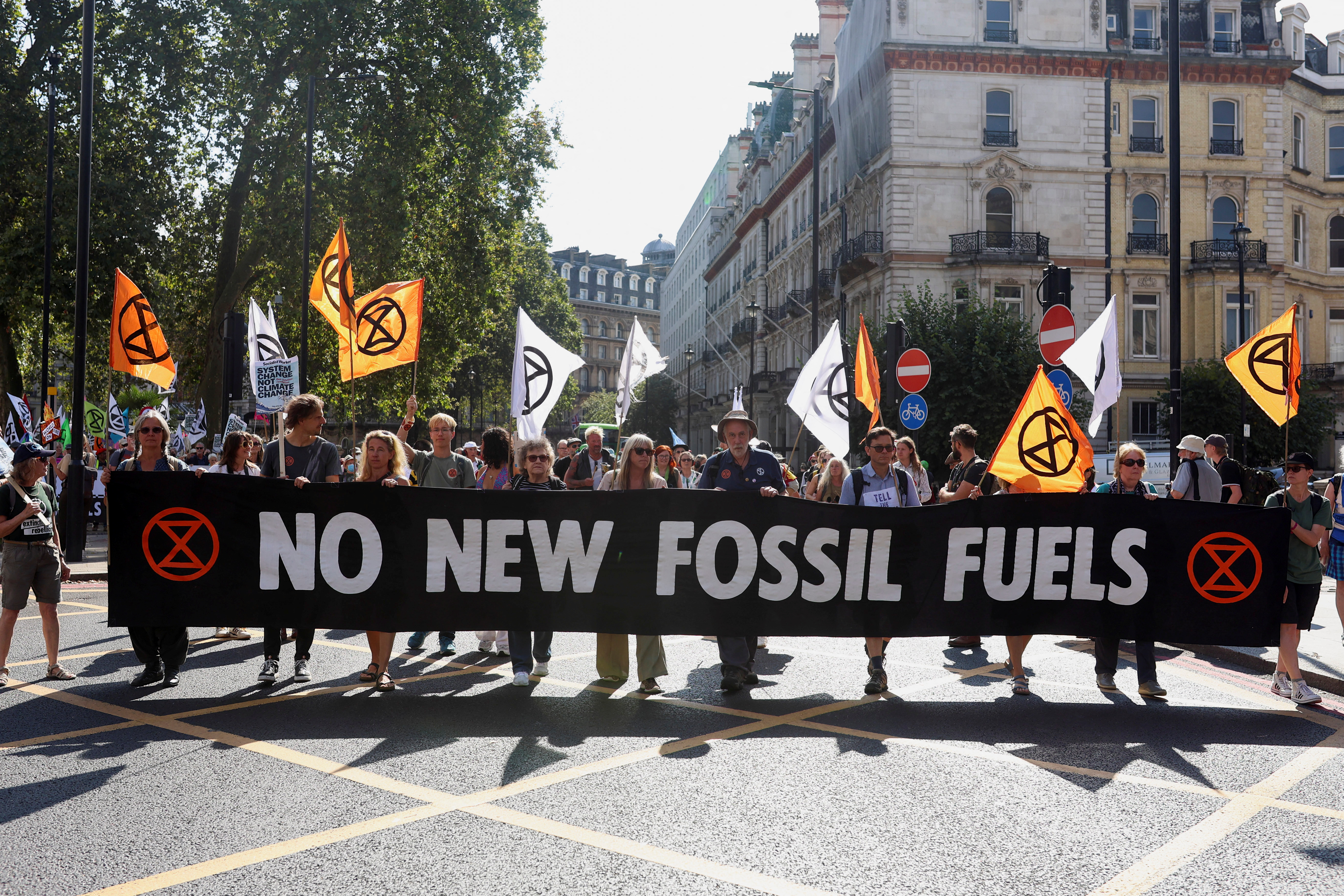 Demonstrators carry a banner during a global protest to end fossil fuels, in London, Britain, September 16, 2023. REUTERS/Susannah Ireland