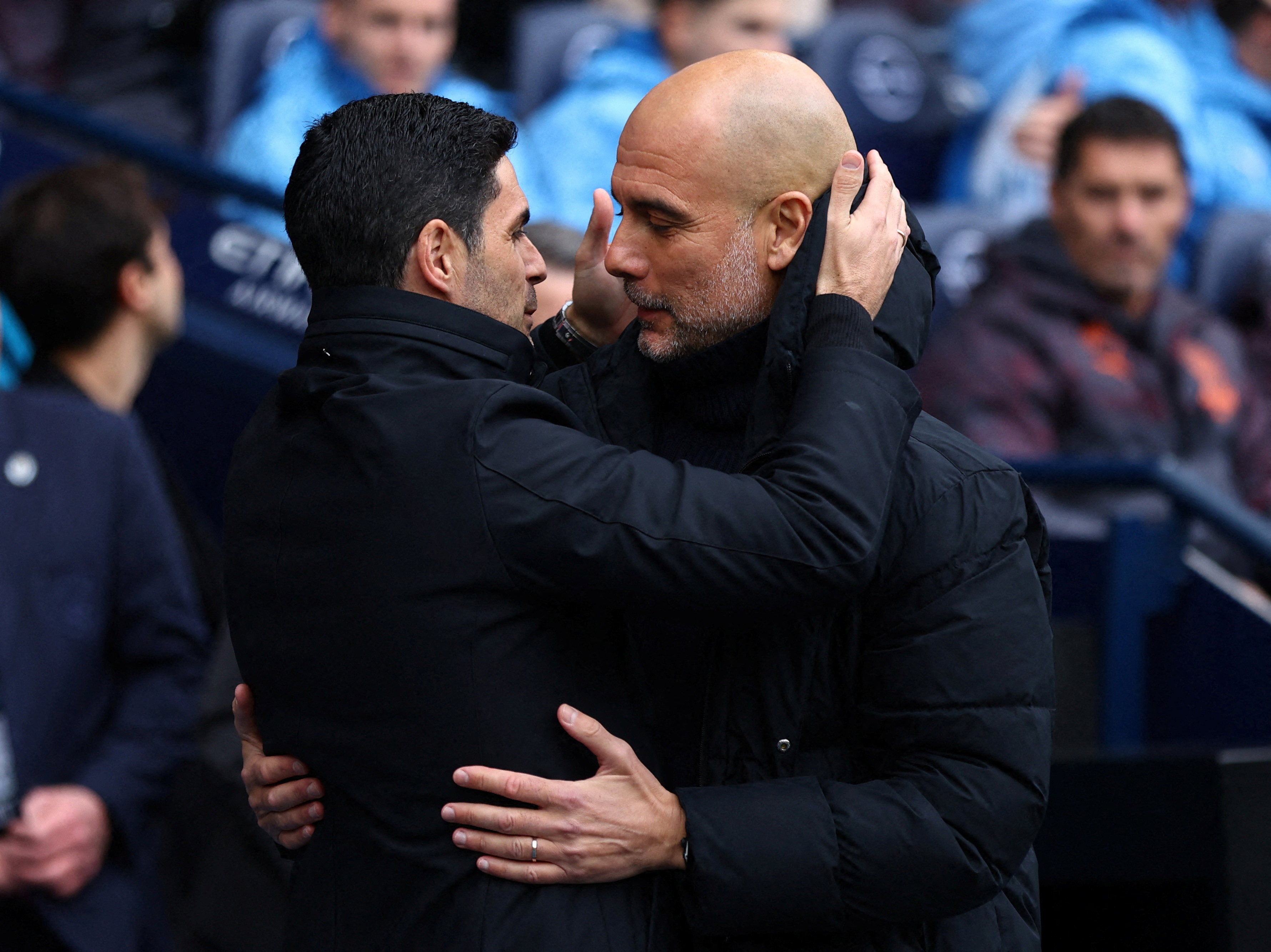 Arsenal manager Mikel Arteta, left, and City manager Pep Guardiola embrace