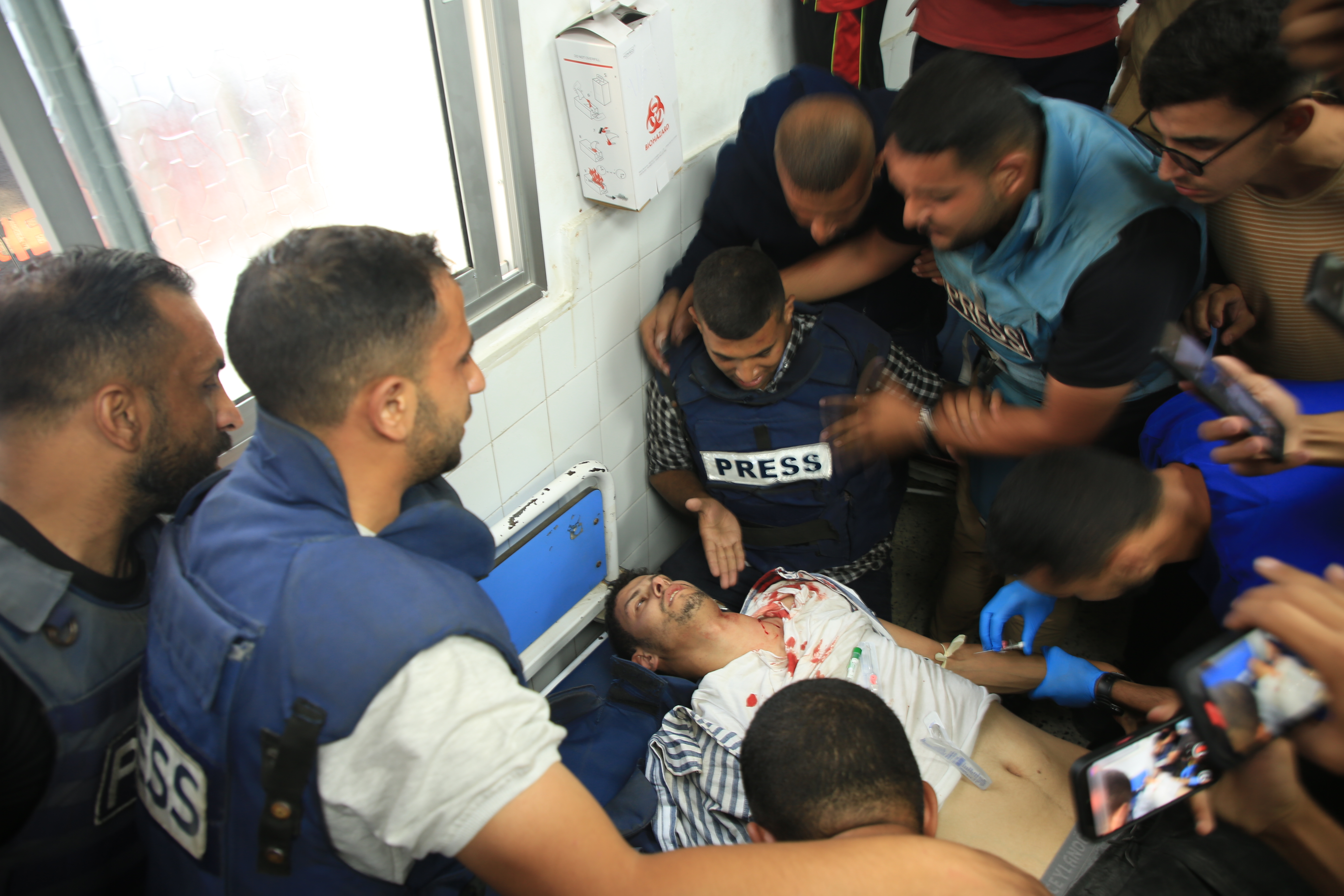 Al Jazeera cameraman Fadi al-Wahidi carried to Al Ahly Hospital for treatment