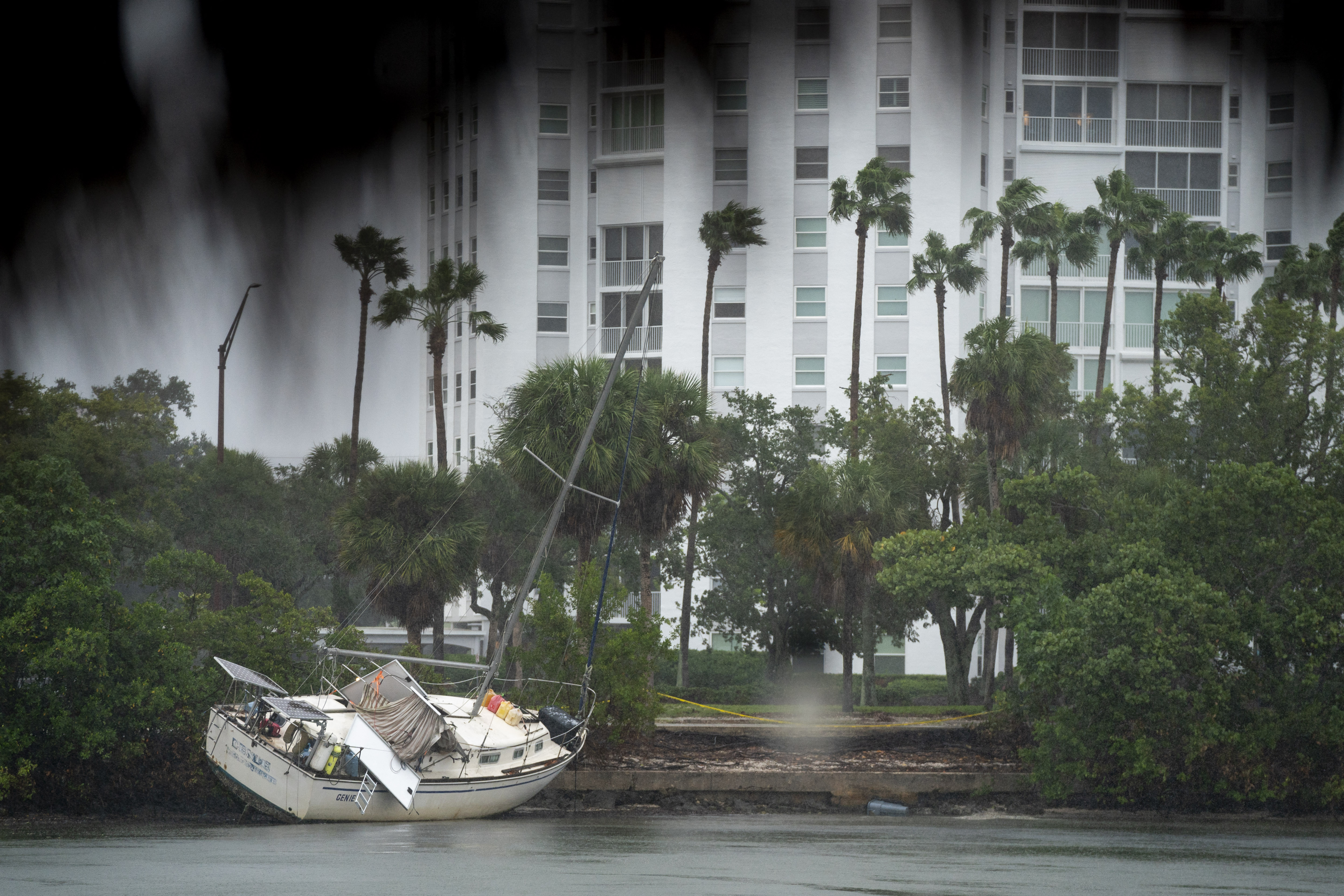 SARASOTA, FLORIDA - OCTOBER 9: A boat run aground from a previous storm rests on the shore as Hurricane Milton approaches on October 9, 2024 in Sarasota, Florida. Forecasts predict the storm to make landfall in the area Wednesday night or Thursday morning. Sean Rayford/Getty Images/AFP (Photo by Sean Rayford / GETTY IMAGES NORTH AMERICA / Getty Images via AFP)
