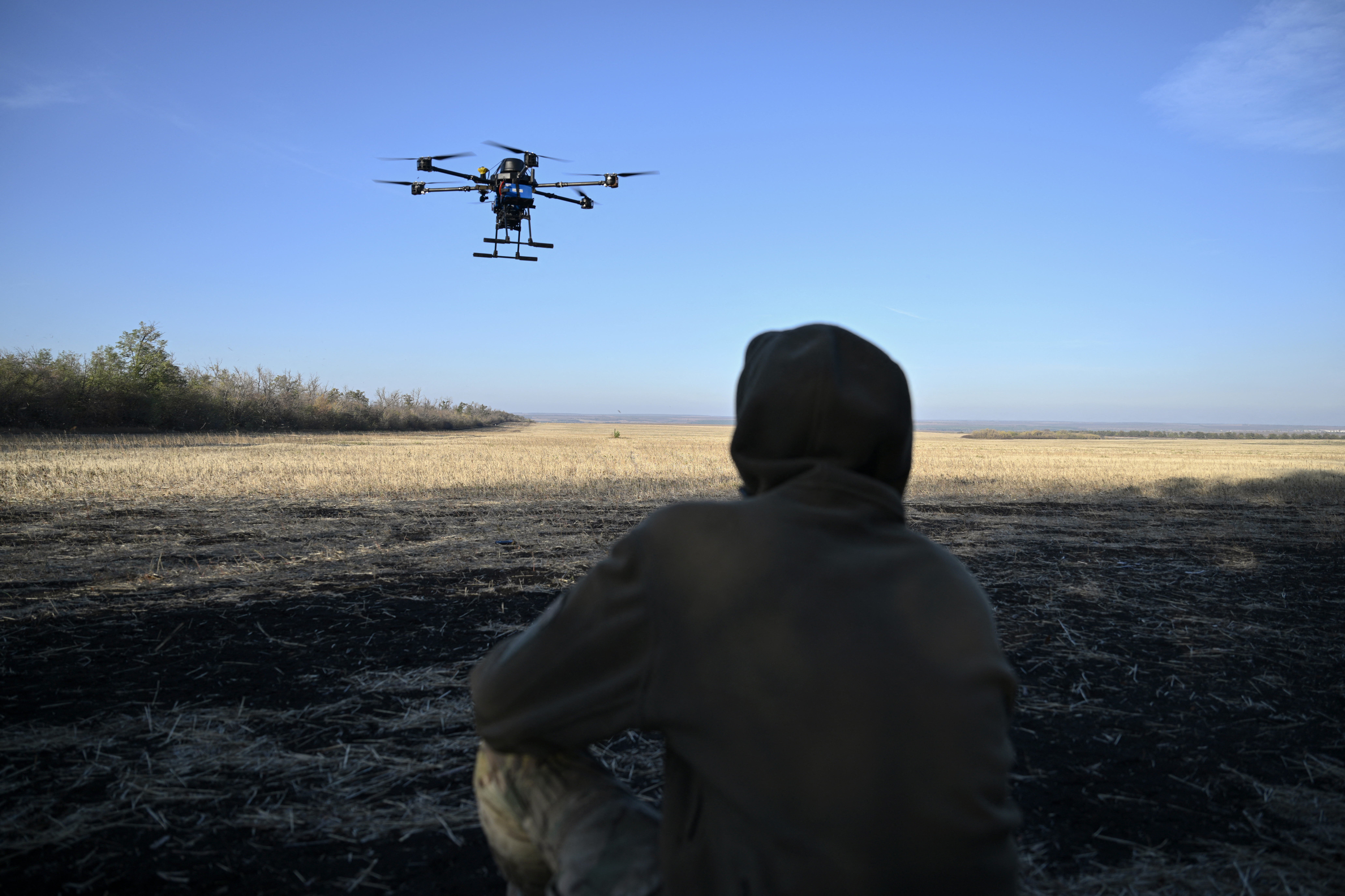 A Ukrainian serviceman of the 30th separate mechanized brigade runs tests flights of a hexacopter drone ahead of battle mission in the eastern Donetsk region on October 22, 2024, amid the Russian invasion of Ukraine. (Photo by Genya SAVILOV / AFP)
