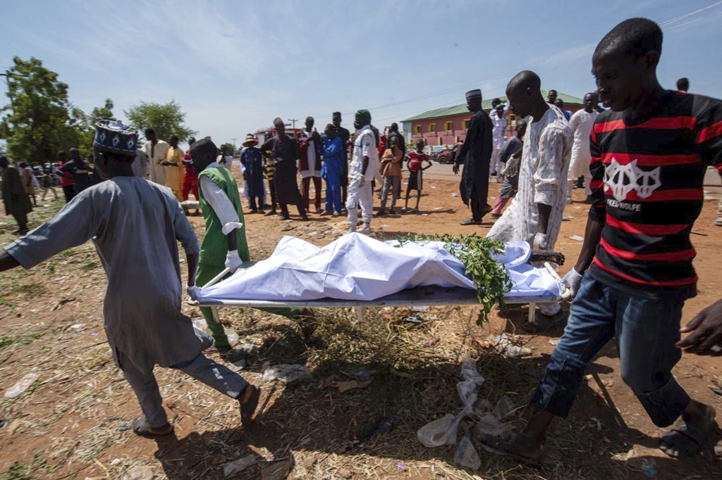 People carry the body of a victim of a tanker explosion for funeral in Majiya town, Nigeria