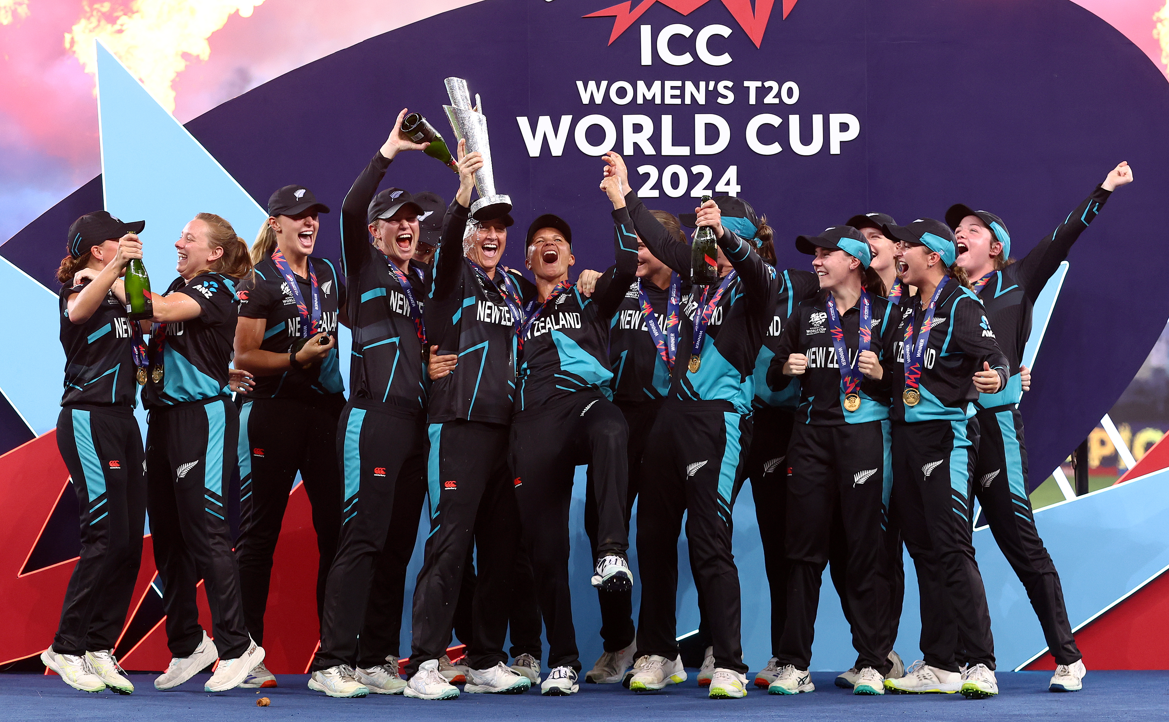DUBAI, UNITED ARAB EMIRATES - OCTOBER 20: Sophie Devine of New Zealand lifts the ICC Women's T20 World Cup Trophy as she celebrates with teammates after defeating South Africa during the ICC Women's T20 World Cup Final 2024 match between South Africa and New Zealand at Dubai International Stadium on October 20, 2024 in Dubai, United Arab Emirates. (Photo by Francois Nel/Getty Images)