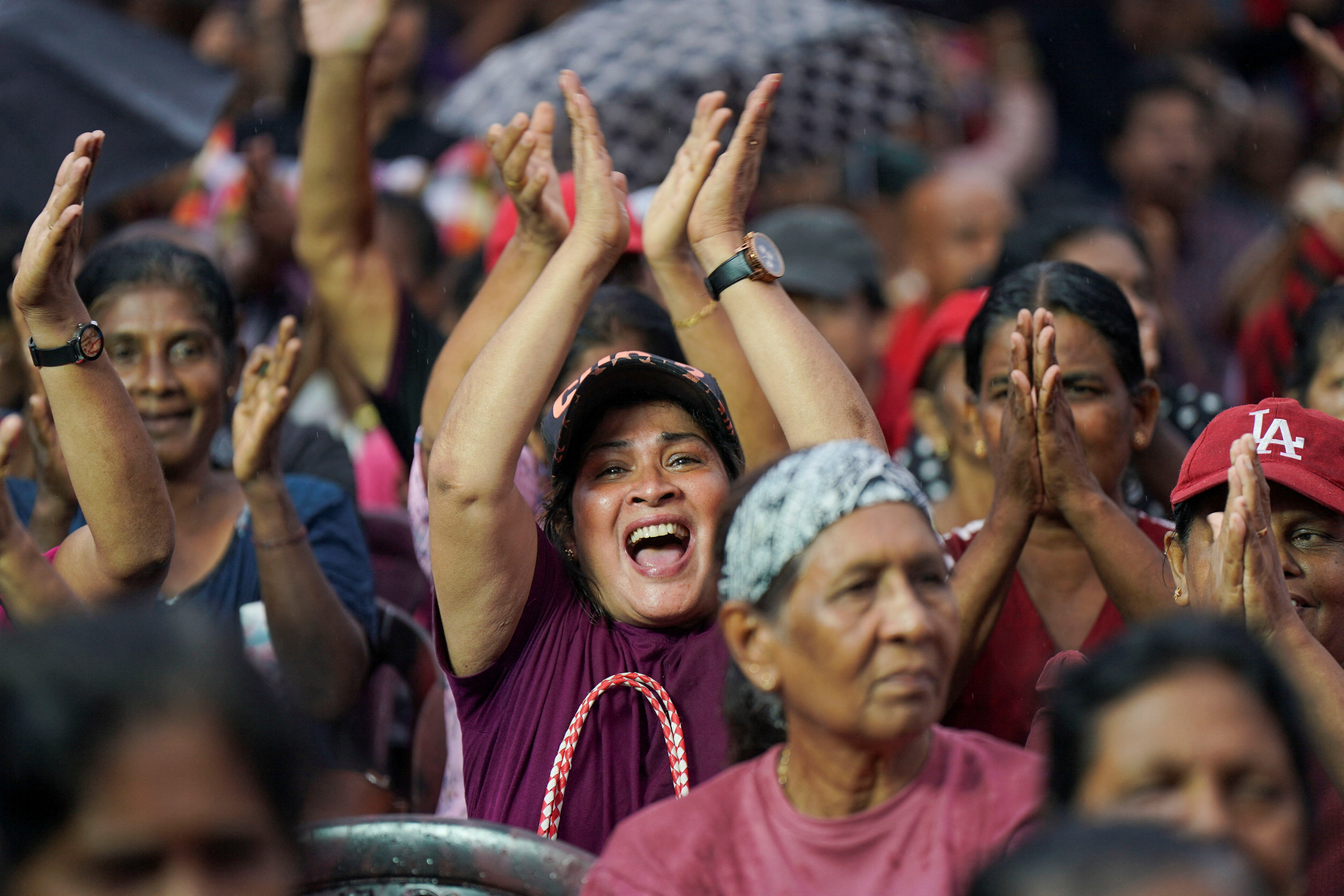 Supporters of the National People's Power (NPP) party clap as they join in an election campaign rally ahead of the 17th Parliamentary Election, in Homagama, Colombo, Sri Lanka, October 20, 2024.